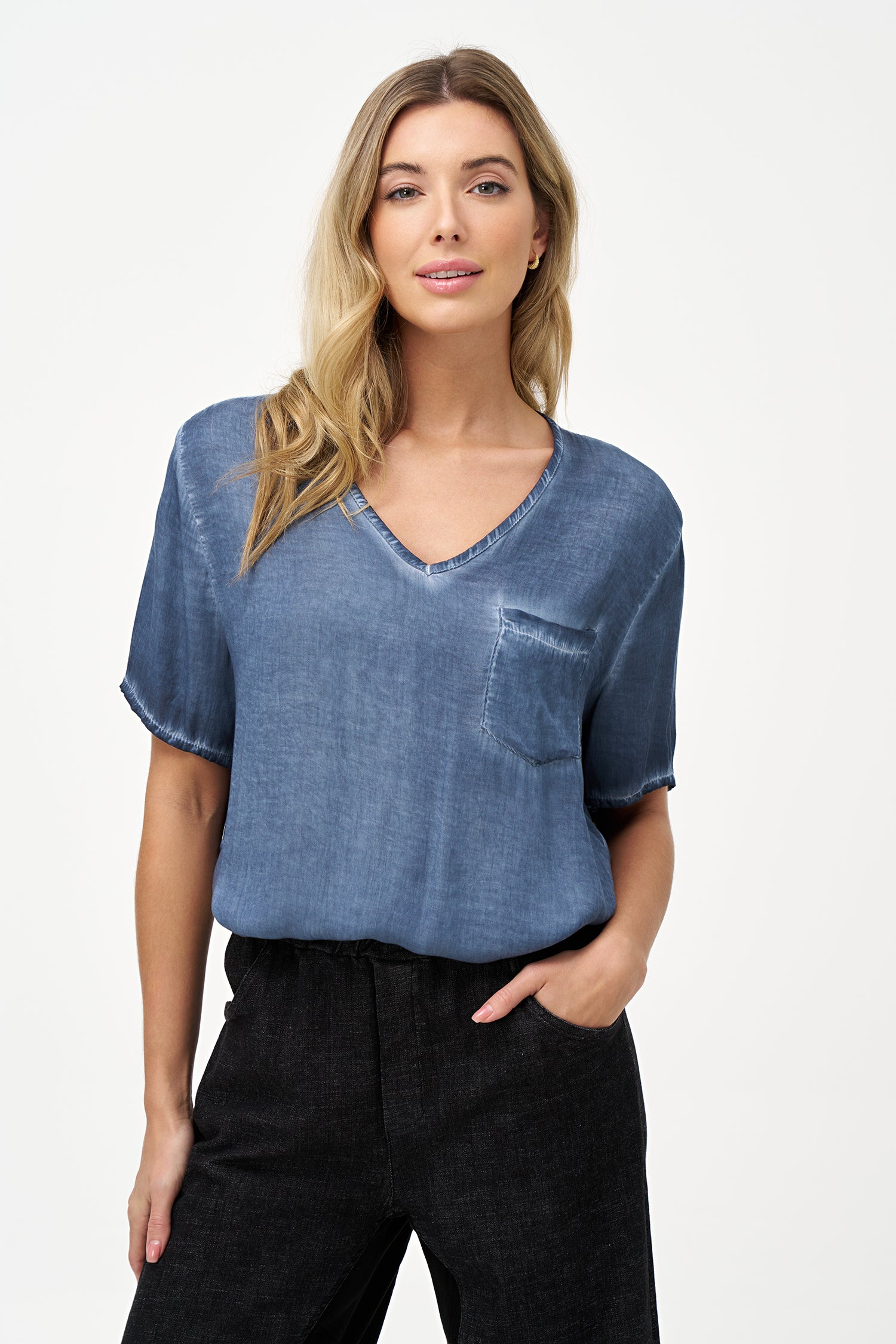 Short sleeve V-neck top in soft blue glacier with raw-edge detailing and chest pocket.