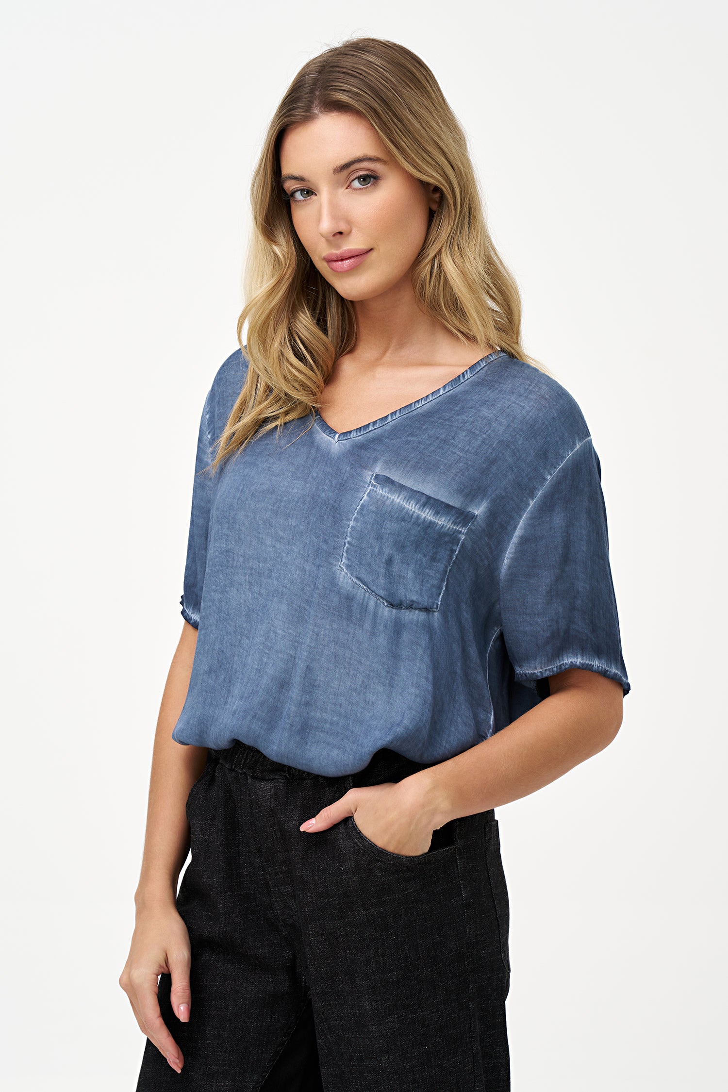 Short sleeve V-neck top in soft blue glacier with raw-edge detailing and chest pocket.