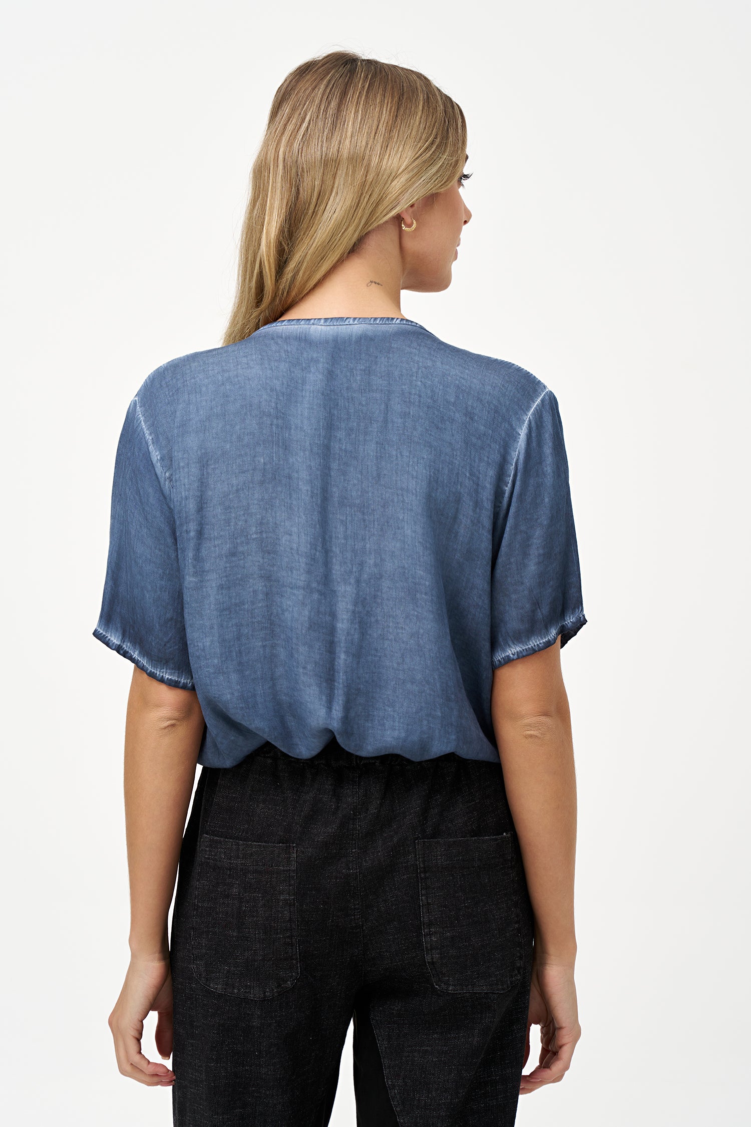 Short sleeve V-neck top in soft blue glacier with raw-edge detailing and chest pocket.