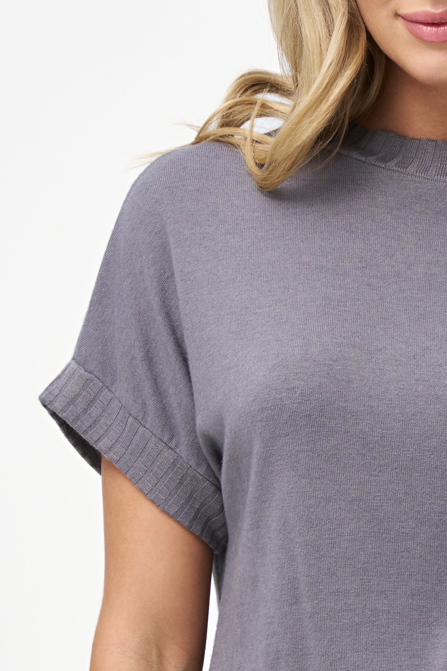 Silver short sleeve knit top with ribbed cuffs, hem, and mock neck.