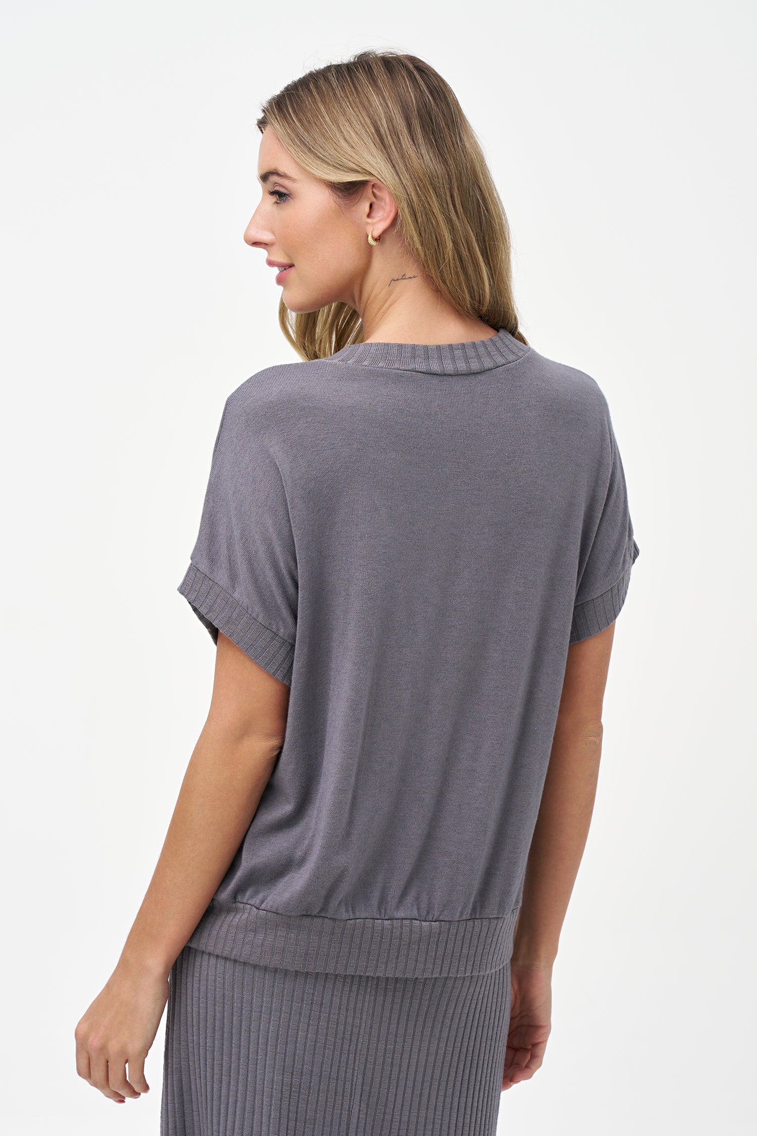 Silver short sleeve knit top with ribbed cuffs, hem, and mock neck.
