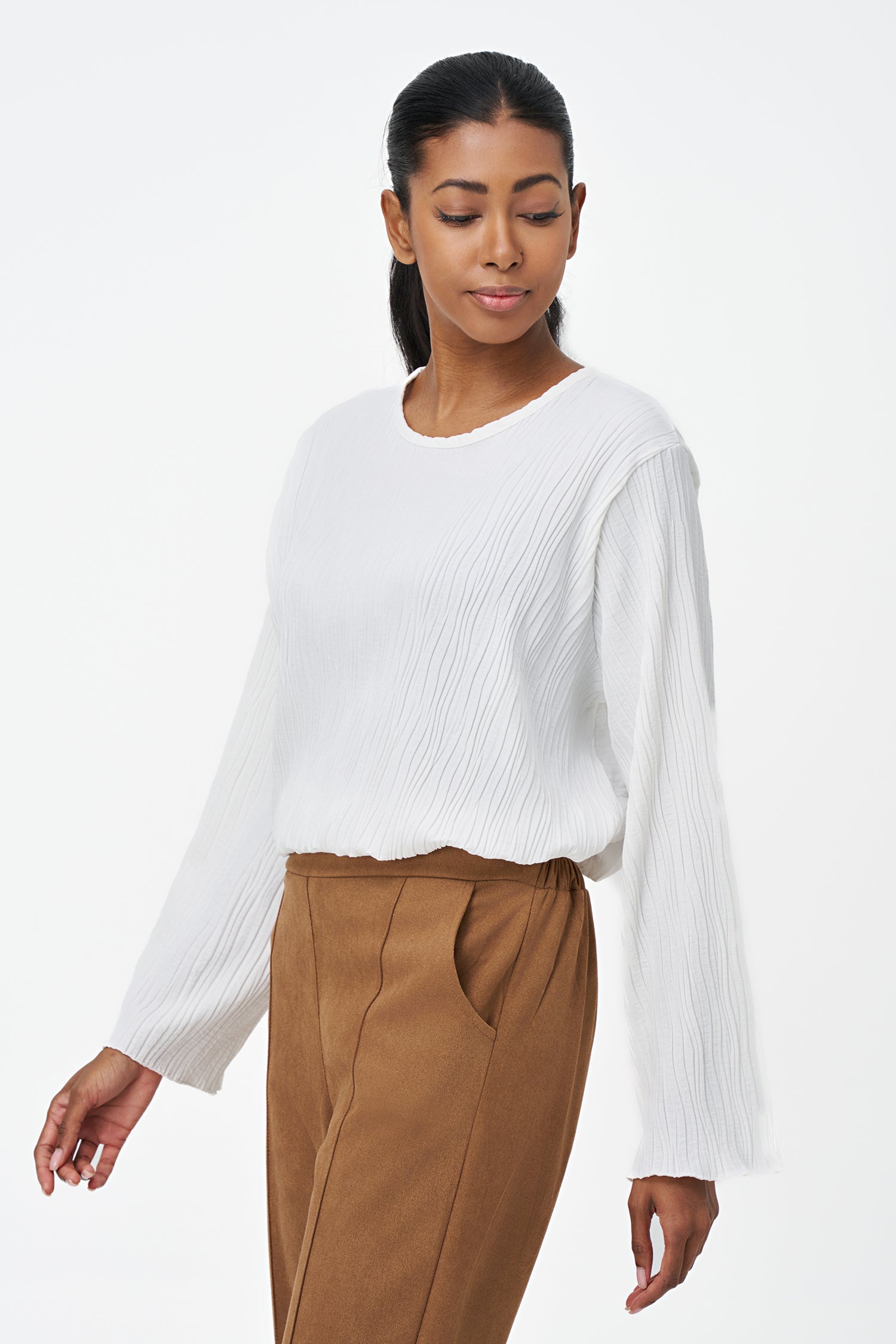 White crinkled long sleeve blouse with round neckline and back keyhole closure.