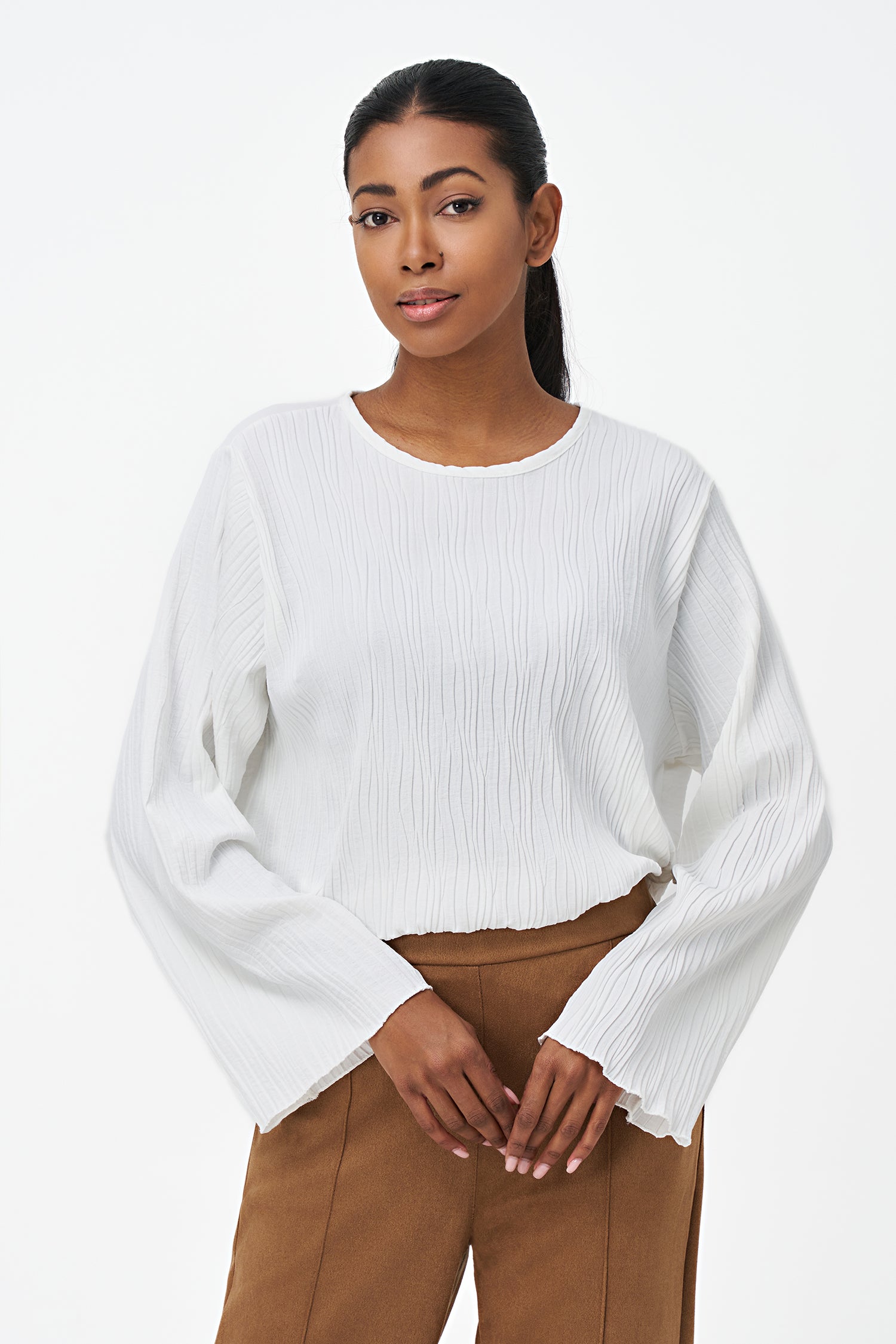 White crinkled long sleeve blouse with round neckline and back keyhole closure.