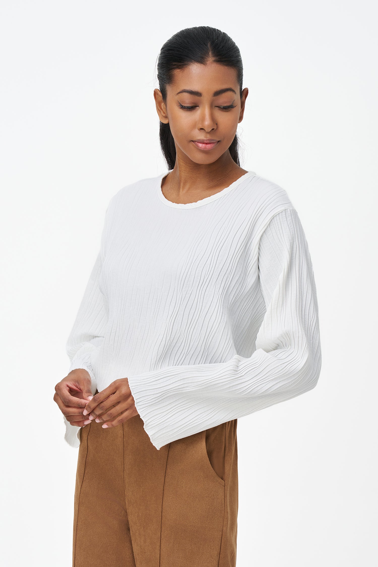 White crinkled long sleeve blouse with round neckline and back keyhole closure.
