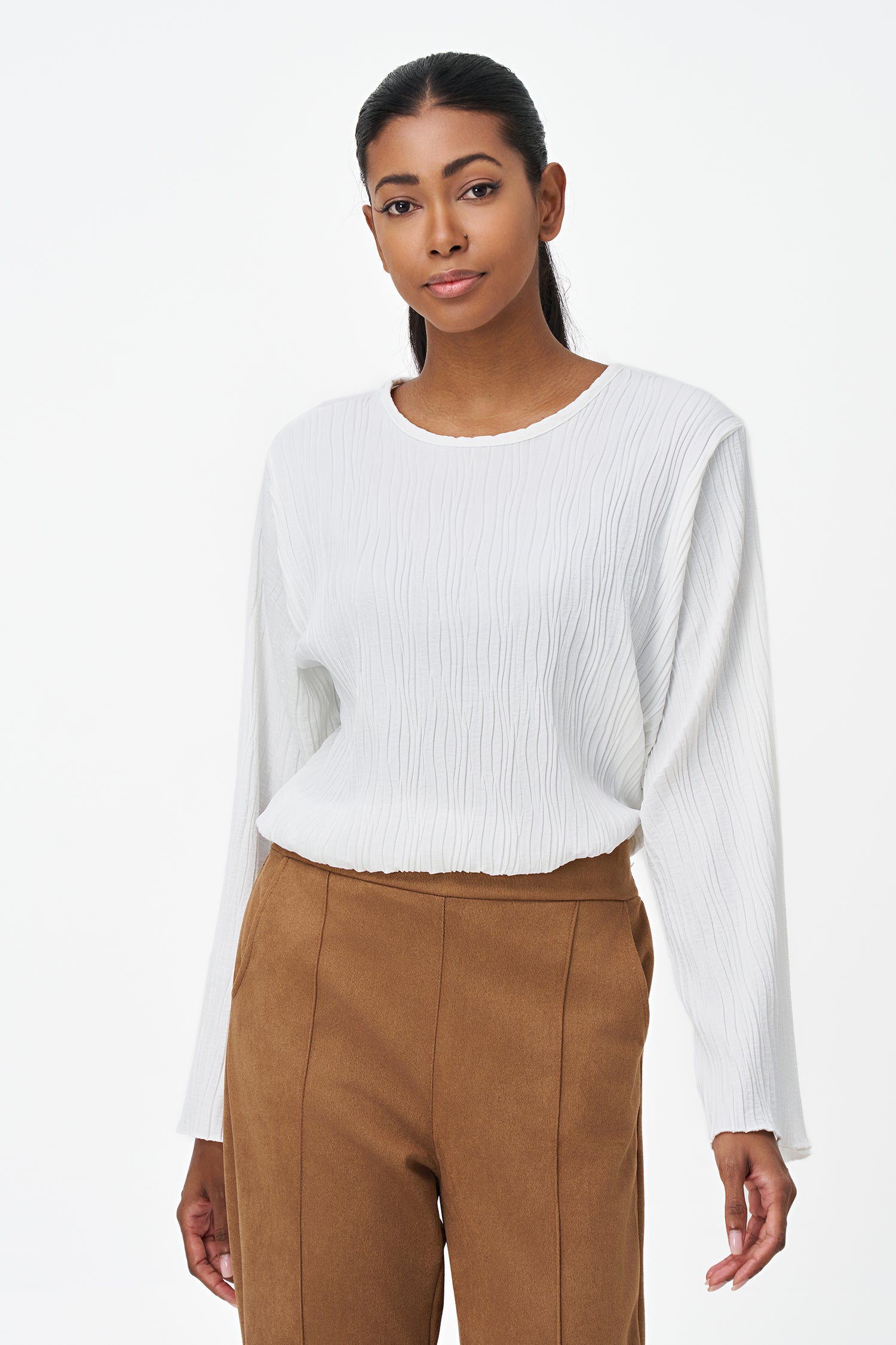White crinkled long sleeve blouse with round neckline and back keyhole closure.