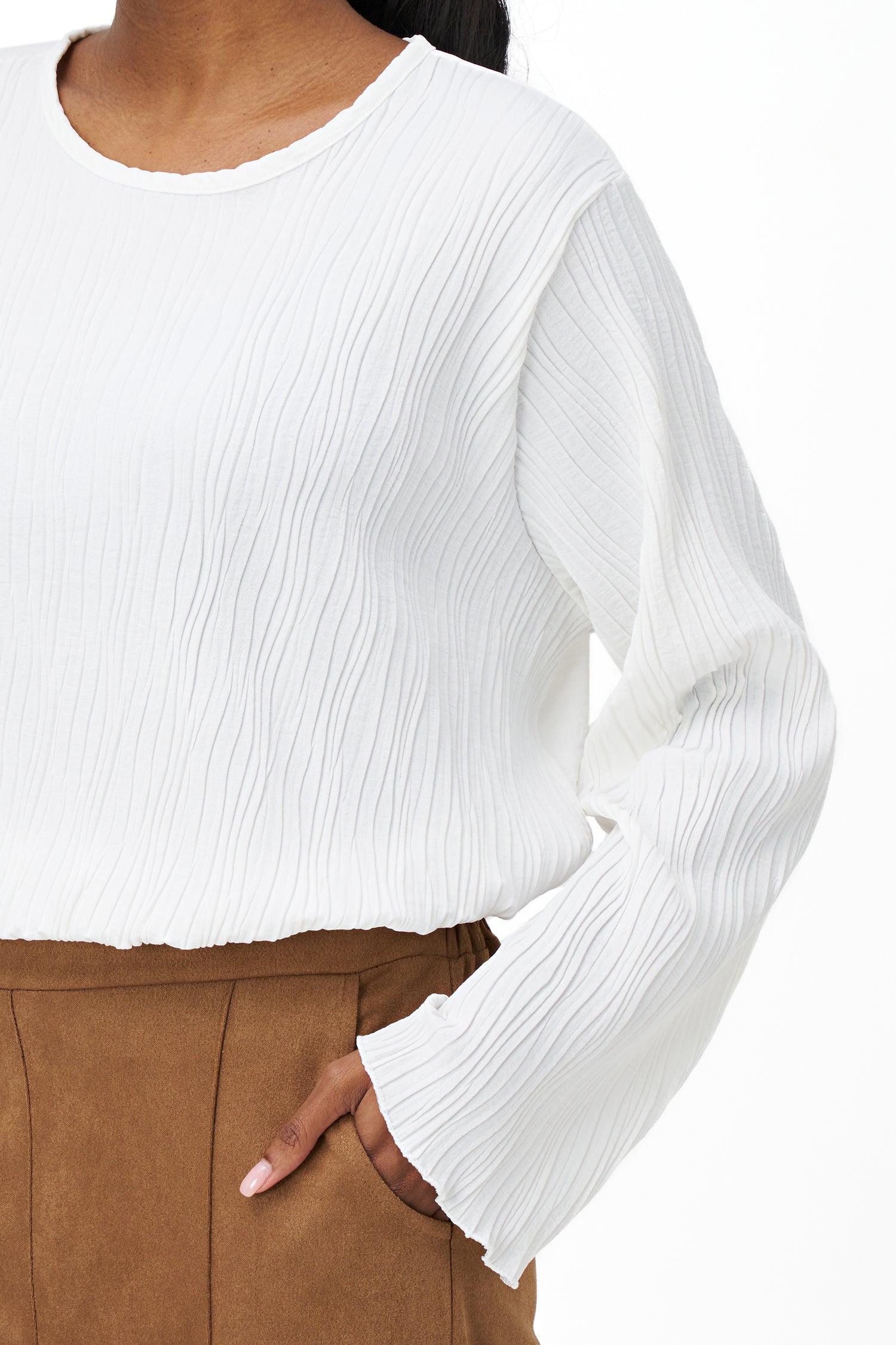 White crinkled long sleeve blouse with round neckline and back keyhole closure.