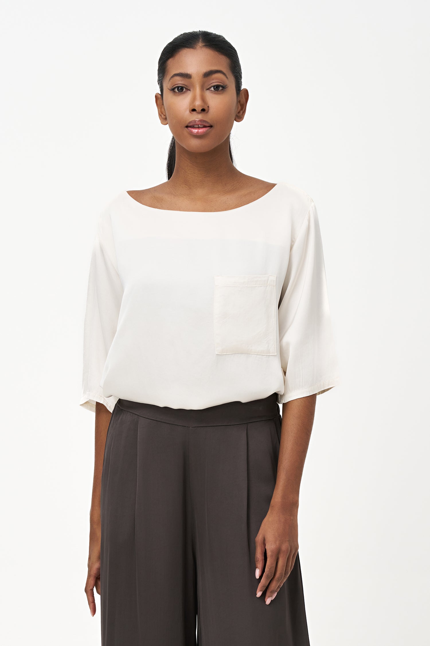 Satin vanilla blouse with elbow-length sleeves and front chest pocket, featuring a relaxed fit and soft sheen.
