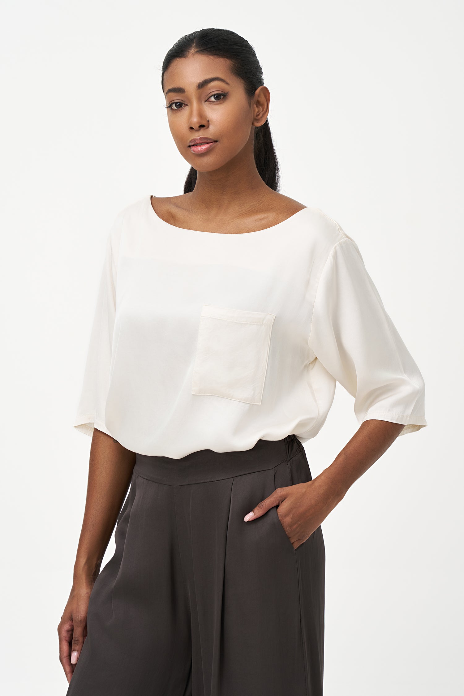 Satin vanilla blouse with elbow-length sleeves and front chest pocket, featuring a relaxed fit and soft sheen.
