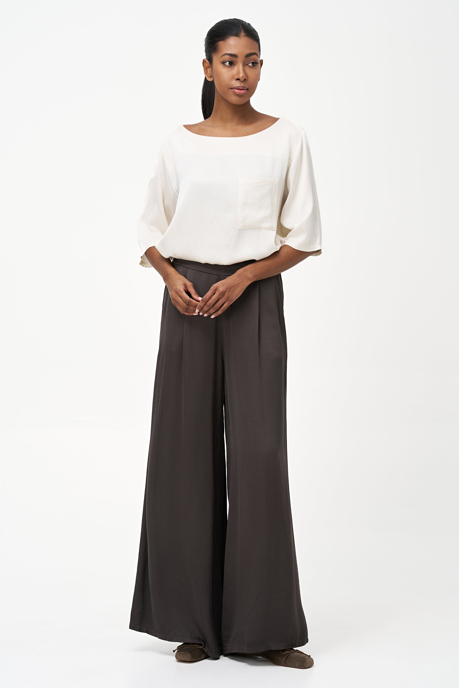Satin vanilla blouse with elbow-length sleeves and front chest pocket, featuring a relaxed fit and soft sheen.