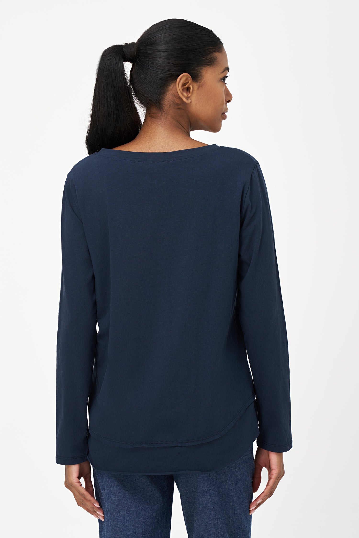 Blue V-neck long-sleeve top with white embroidered floral design and cursive script reading 'Beautiful, Bonjour, Fleur' on the front.