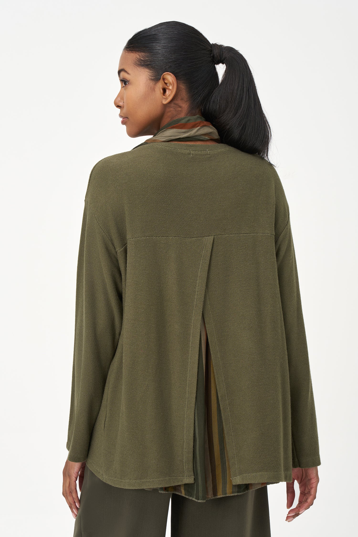 Olive green long sleeve top with a rounded hem and attached multicolor striped scarf, perfect for fall layering.
