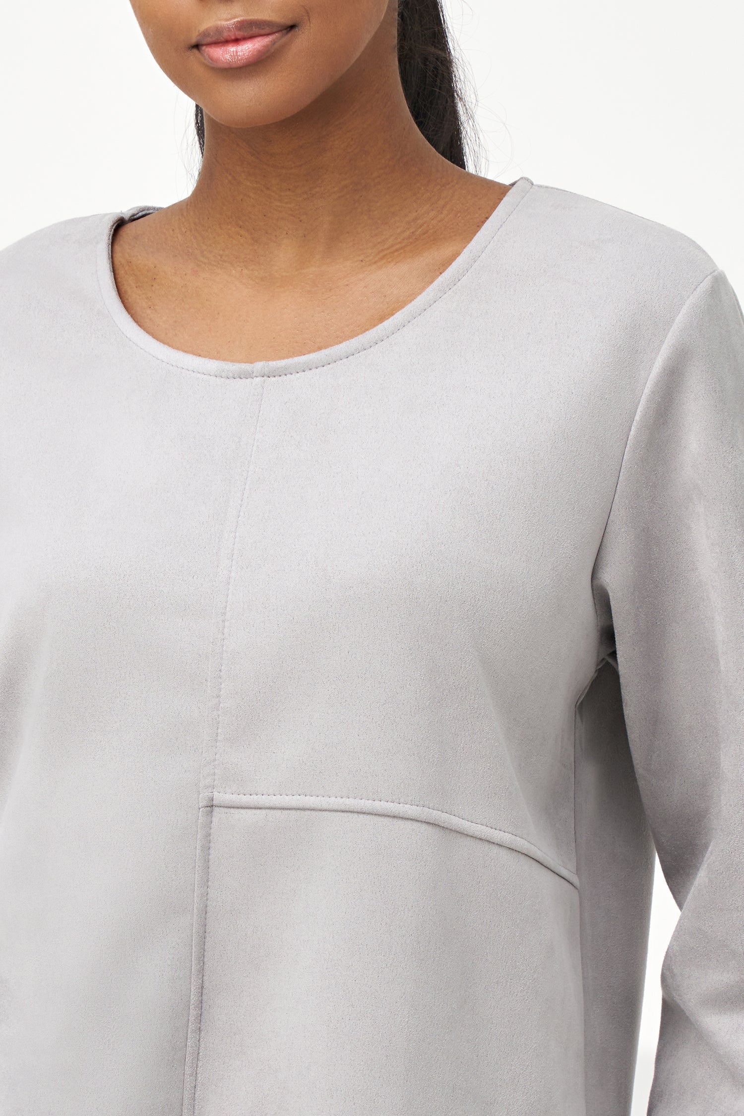 Grey faux suede long sleeve top with asymmetrical hem and front seam detailing.