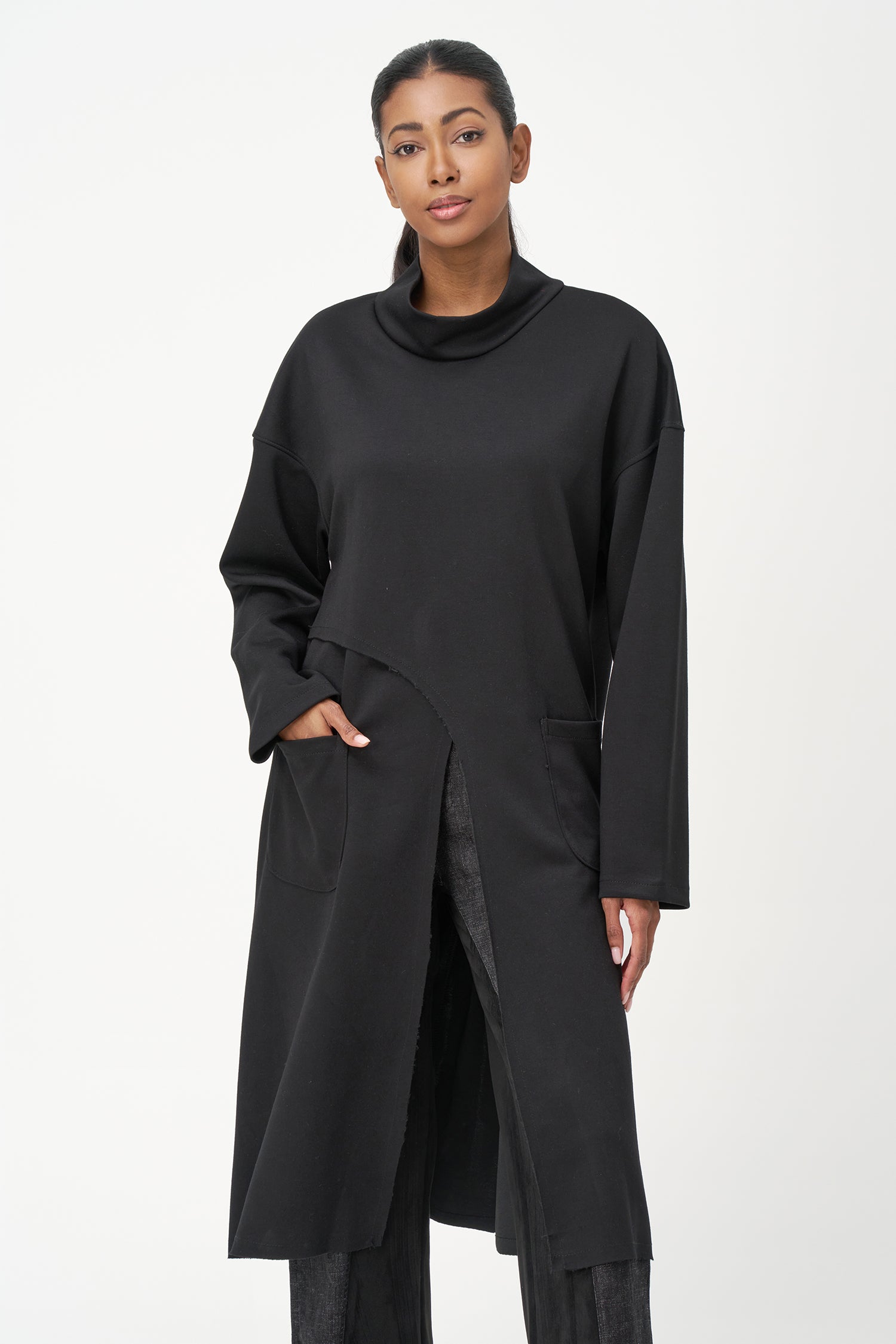 Black long sleeve mock neck dress with asymmetrical front seam and rounded side patch pocket