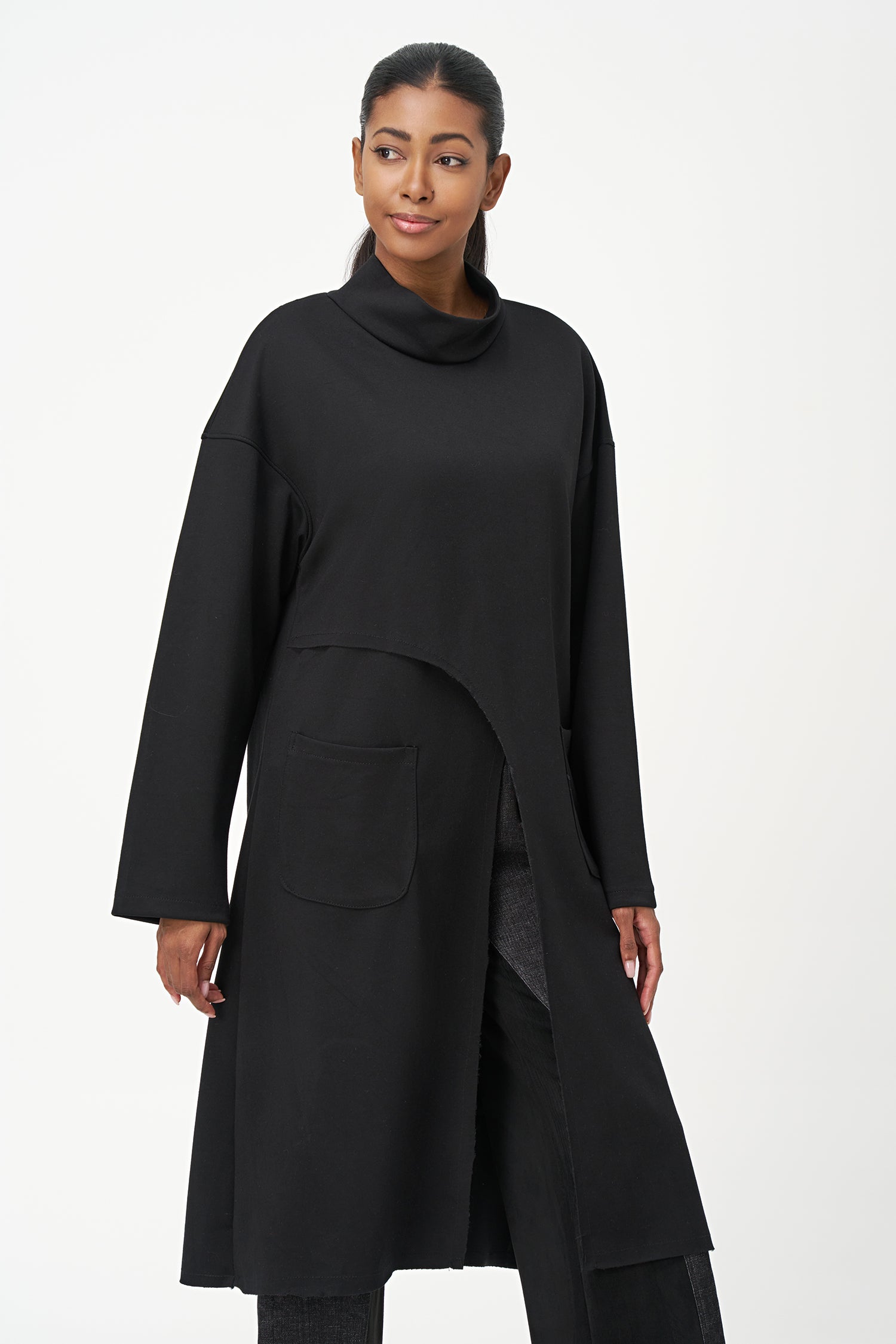 Black long sleeve mock neck dress with asymmetrical front seam and rounded side patch pocket