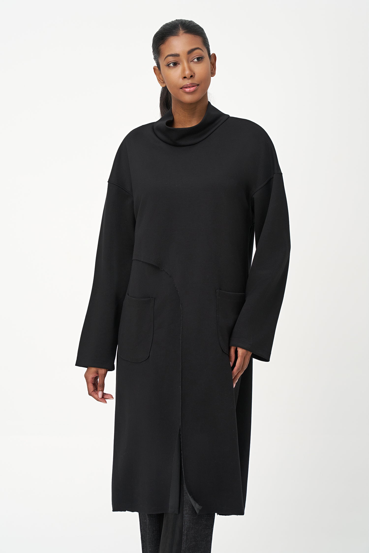 Black long sleeve mock neck dress with asymmetrical front seam and rounded side patch pocket