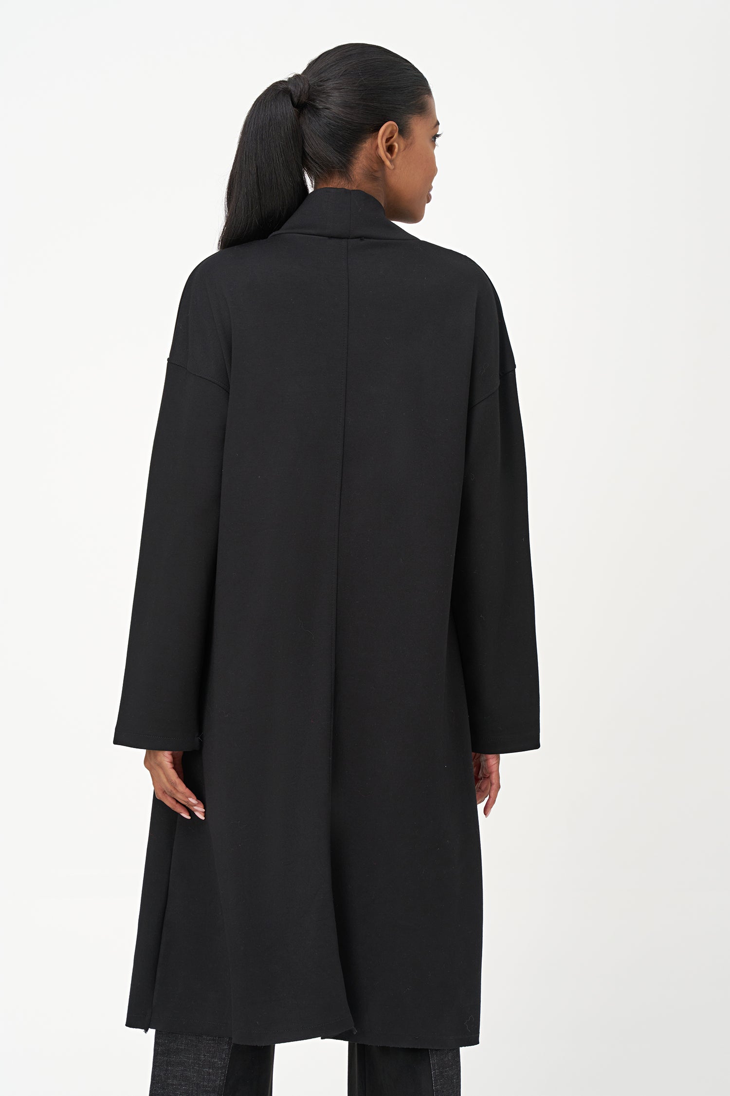 Black long sleeve mock neck dress with asymmetrical front seam and rounded side patch pocket