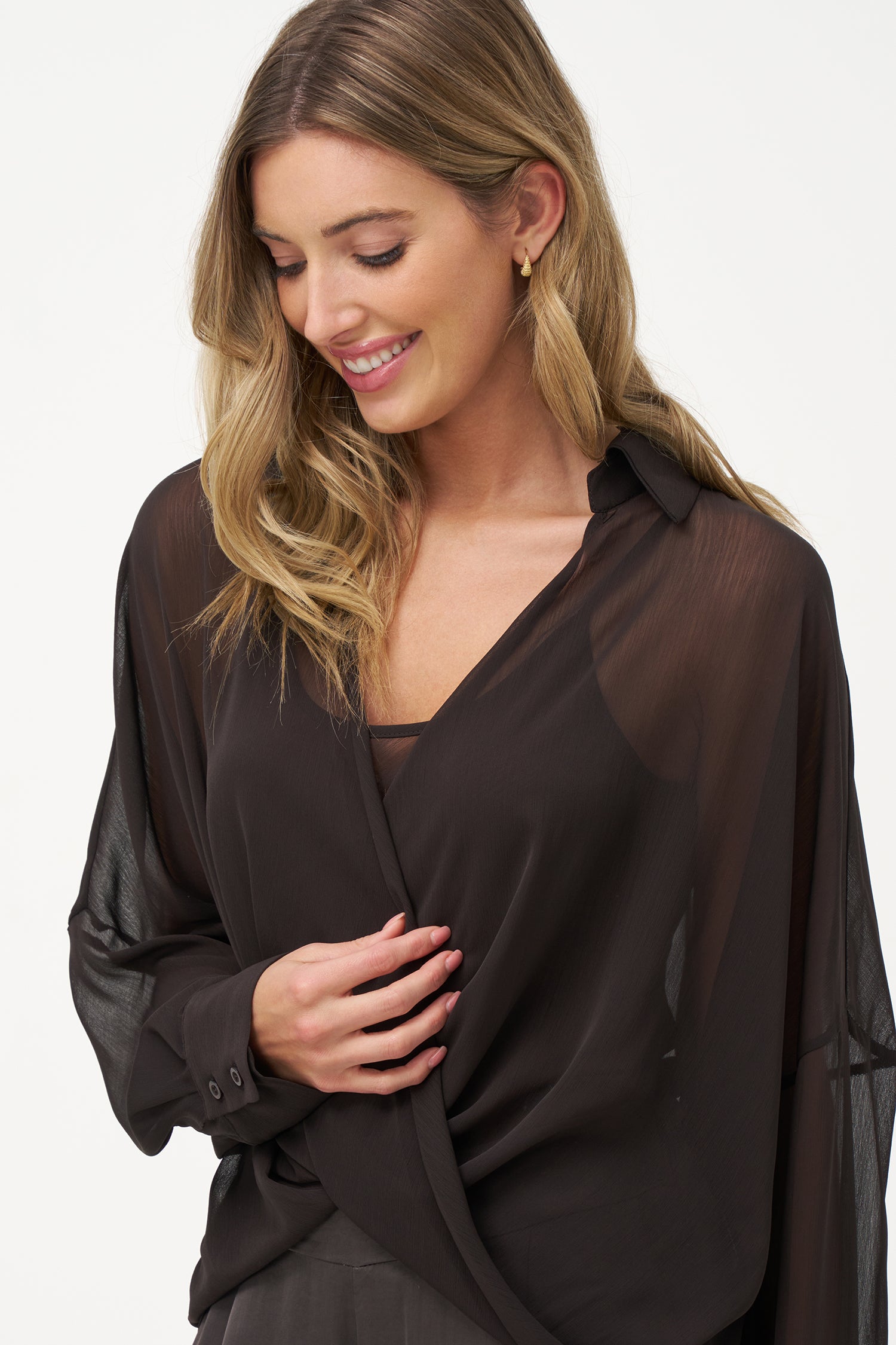 Brown sheer long-sleeve blouse with draped crossover front and inner tank layer