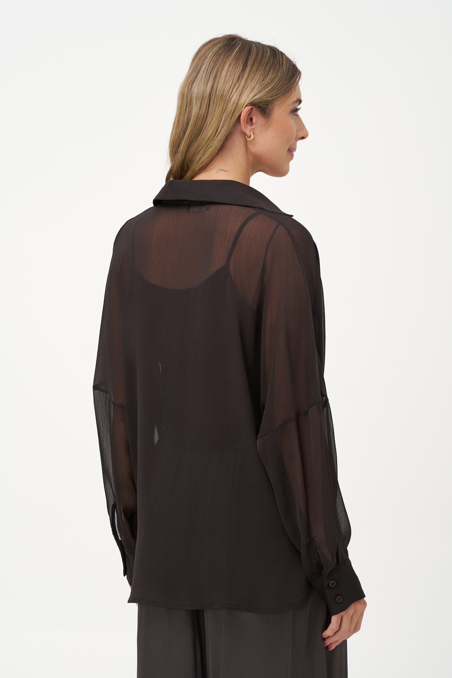 Brown sheer long-sleeve blouse with draped crossover front and inner tank layer