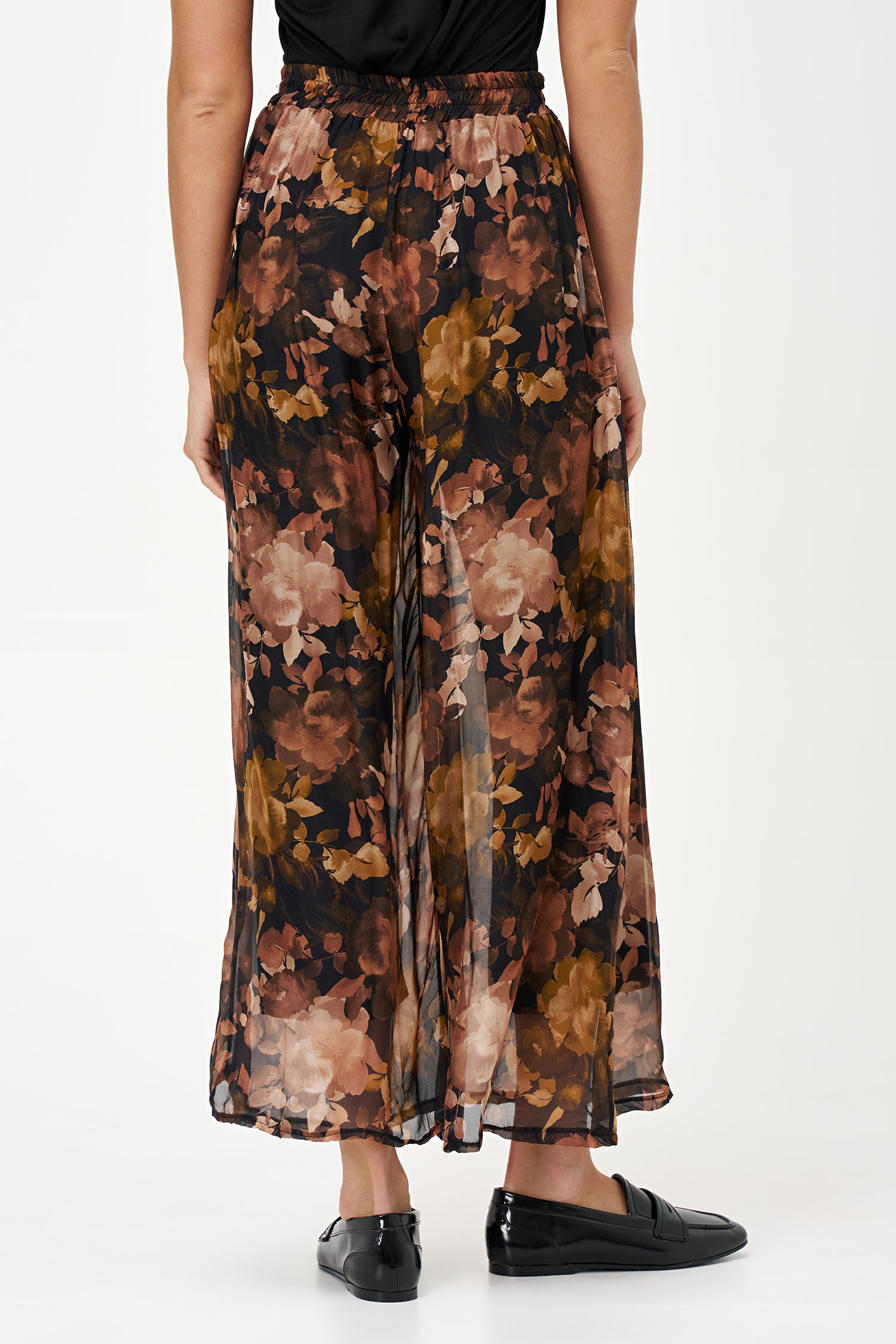 Sheer wide-leg pants in floral black Daphne print with flowy silk-viscose blend, ideal for garden parties or summer evenings.