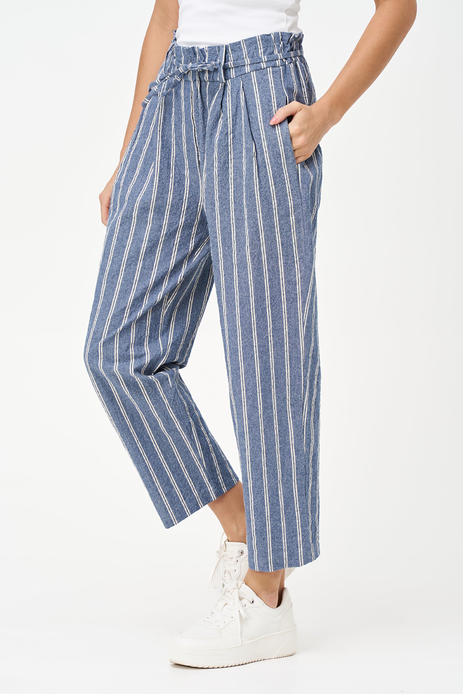 Blue striped cotton pants with tie-waist detail, cropped ankle length, and a tailored yet relaxed silhouette.