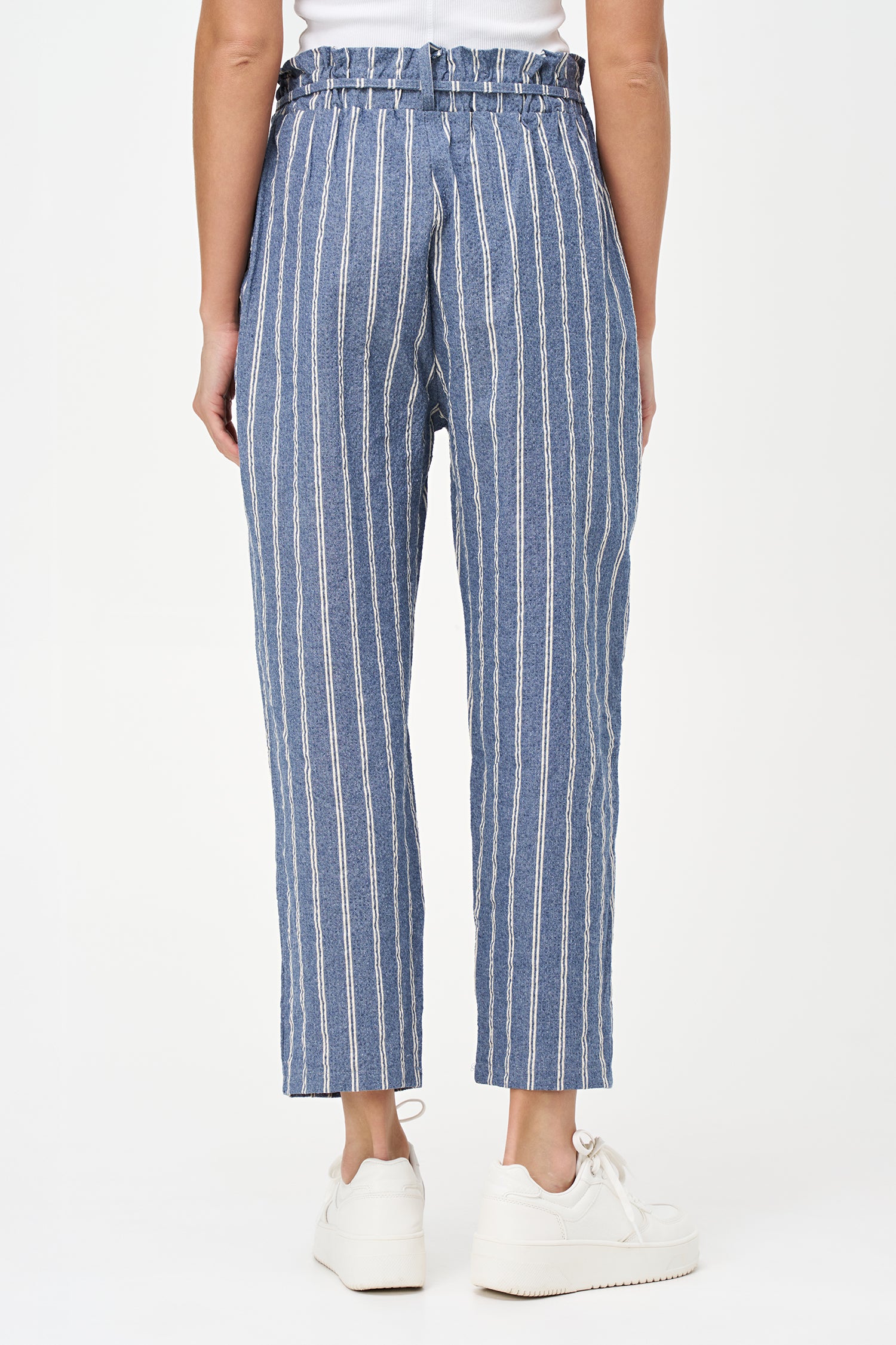 Blue striped cotton pants with tie-waist detail, cropped ankle length, and a tailored yet relaxed silhouette.
