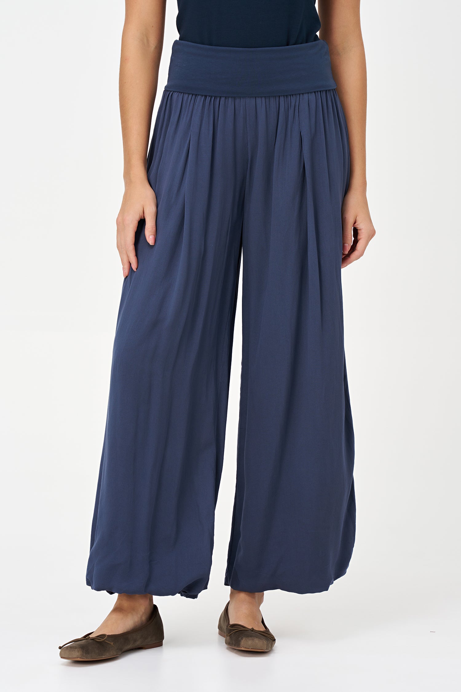 Blue-colored wide-leg pants with a soft elastic waistband and pleated front, made from 100% viscose.