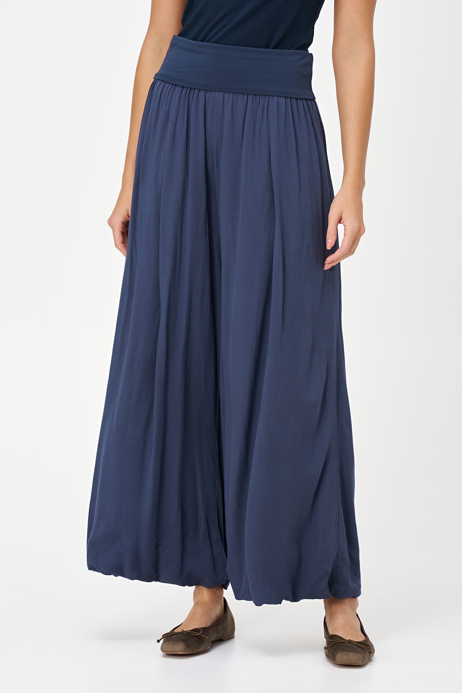 Blue-colored wide-leg pants with a soft elastic waistband and pleated front, made from 100% viscose.