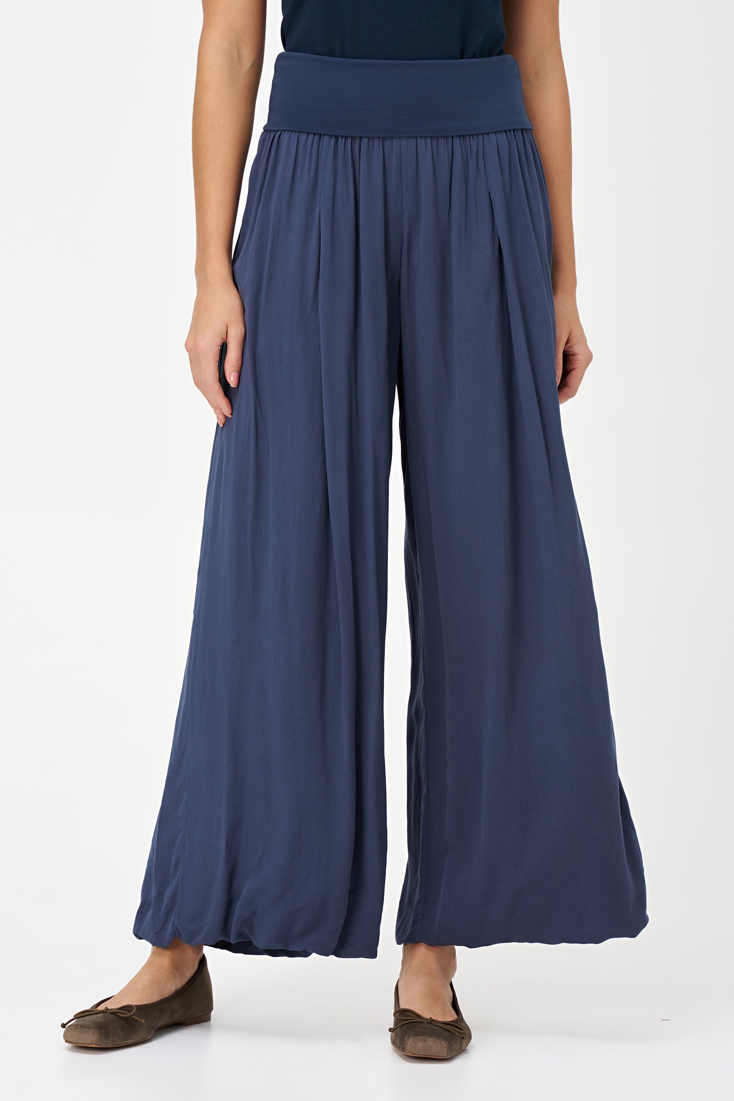 Blue-colored wide-leg pants with a soft elastic waistband and pleated front, made from 100% viscose.