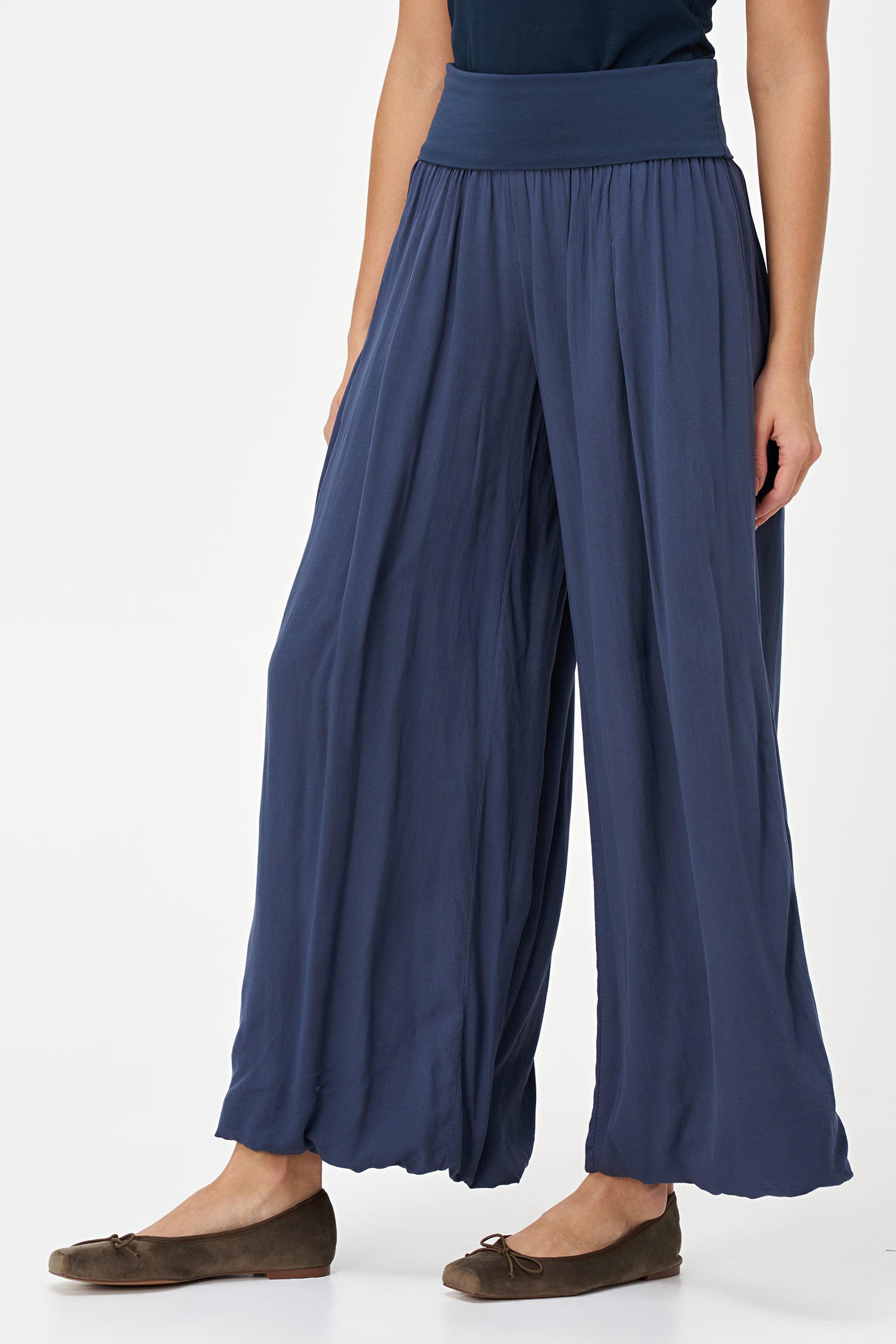 Blue-colored wide-leg pants with a soft elastic waistband and pleated front, made from 100% viscose.
