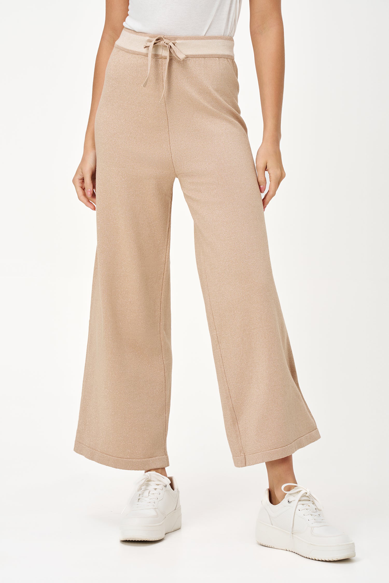 Golden lurex knit wide-leg pants with contrast waistband and drawstring, offering stretch comfort and subtle shimmer for festive looks.