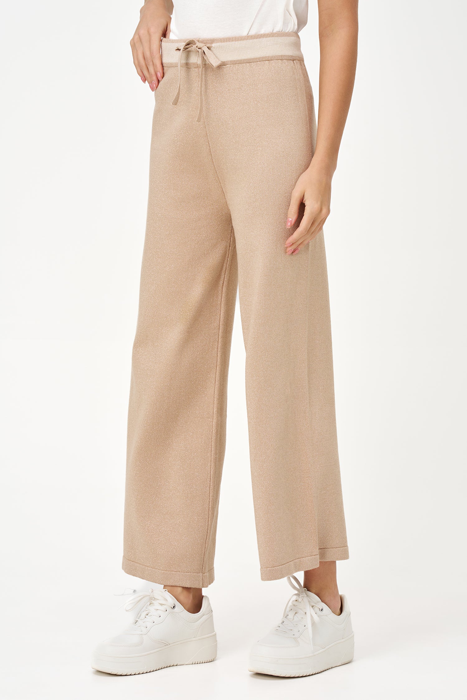 Golden lurex knit wide-leg pants with contrast waistband and drawstring, offering stretch comfort and subtle shimmer for festive looks.