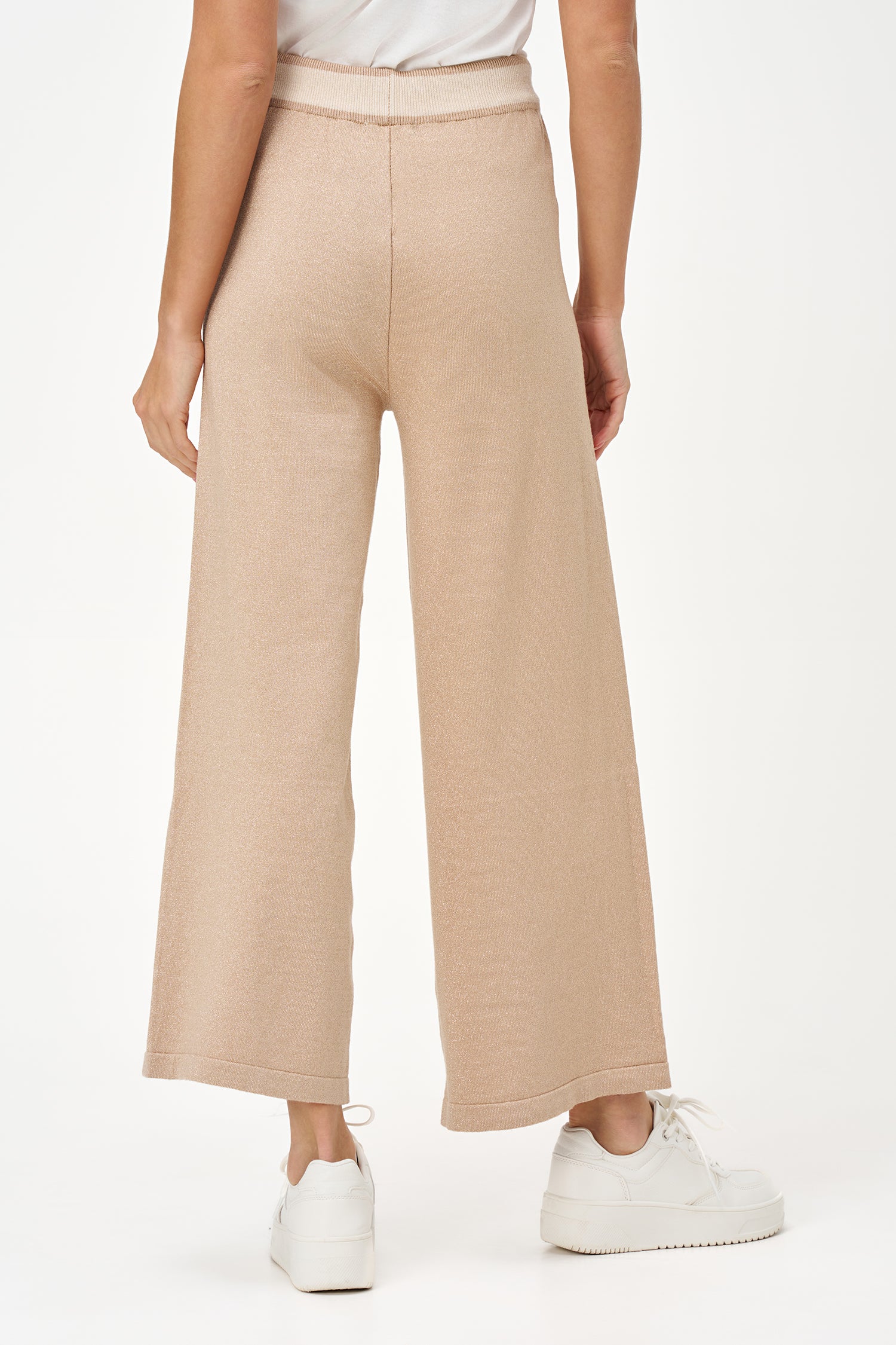 Golden lurex knit wide-leg pants with contrast waistband and drawstring, offering stretch comfort and subtle shimmer for festive looks.