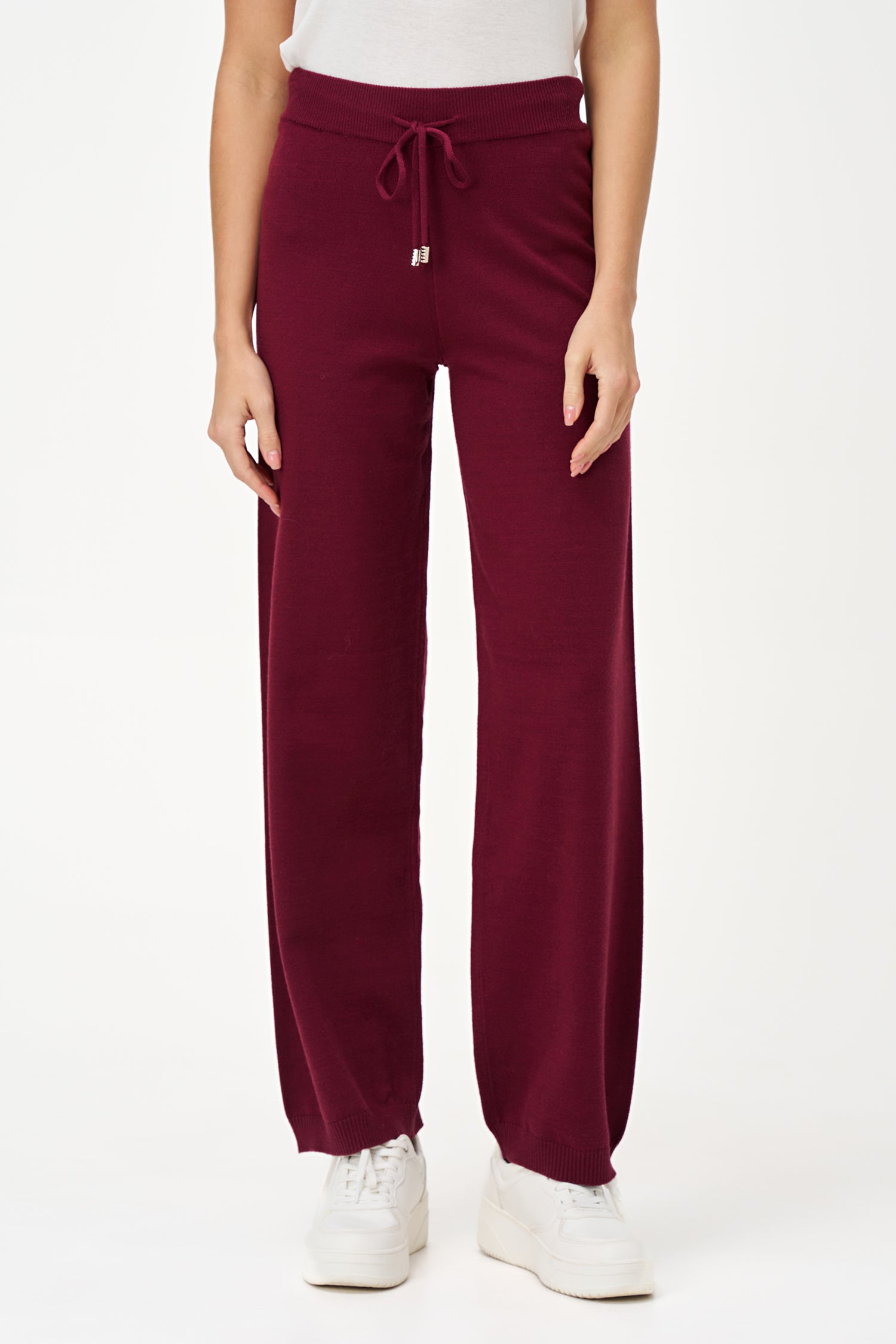 Red knit jogger pants with drawstring waist and cuffed hem, crafted in a soft rayon-blend for cozy everyday wear.
