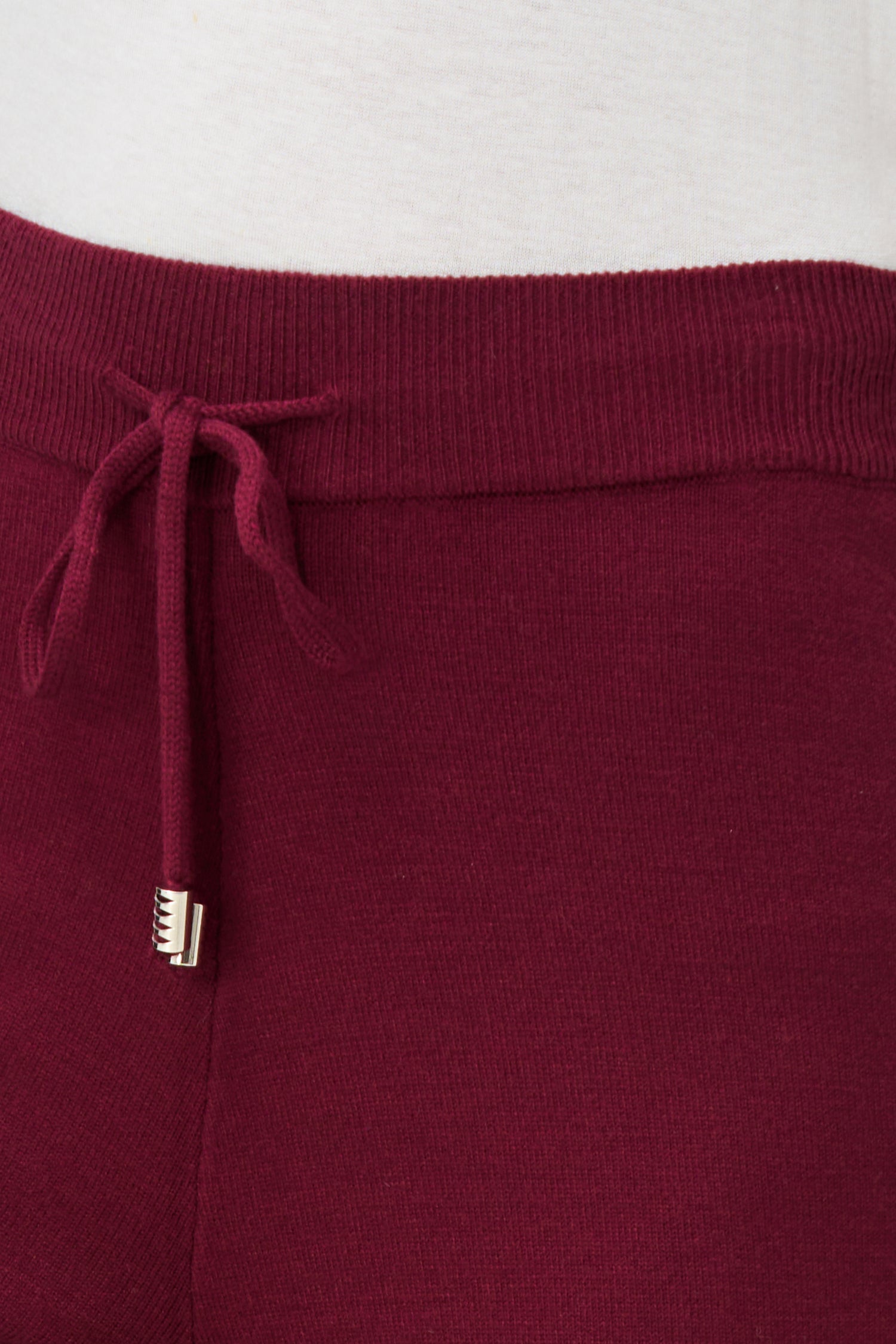 Red knit jogger pants with drawstring waist and cuffed hem, crafted in a soft rayon-blend for cozy everyday wear.