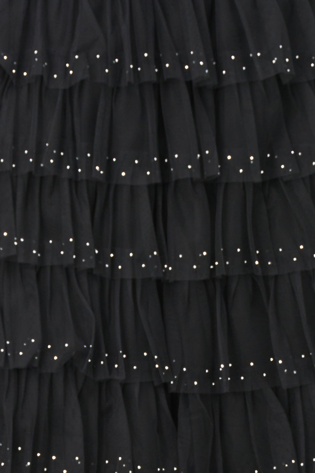 Black layered tulle maxi skirt with ruffled tiers and subtle sparkle embellishments, perfect for special occasions or evening wear.
