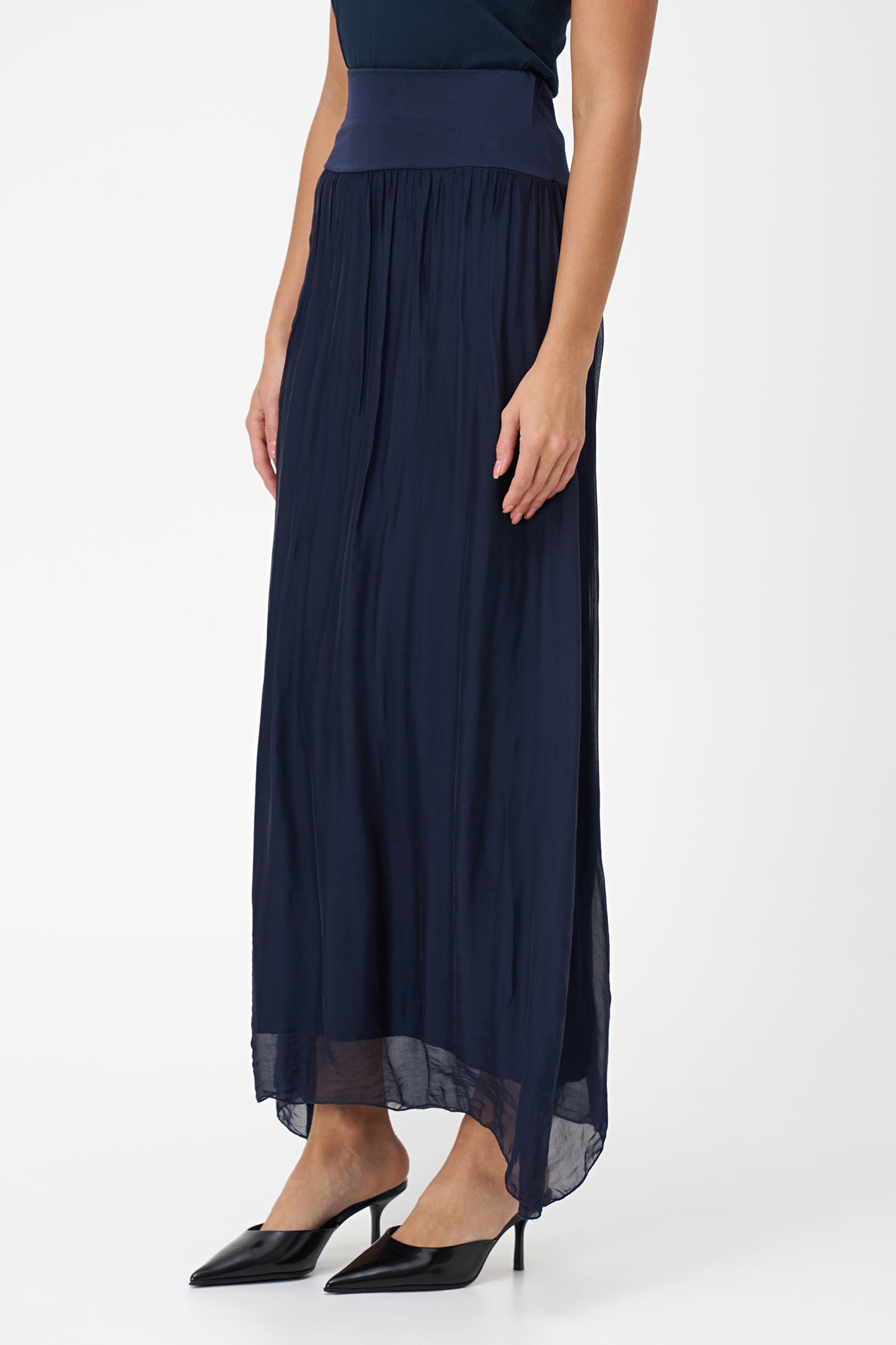 Blue flowy maxi skirt in semi-sheer viscose-silk blend with wide smocked waistband, perfect for summer occasions and beach getaways.