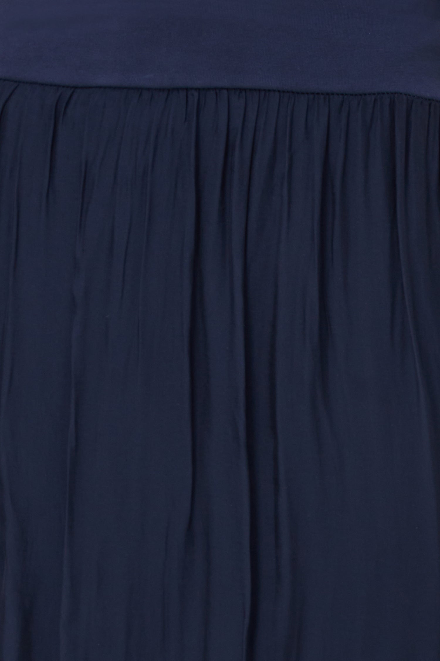 Blue flowy maxi skirt in semi-sheer viscose-silk blend with wide smocked waistband, perfect for summer occasions and beach getaways.