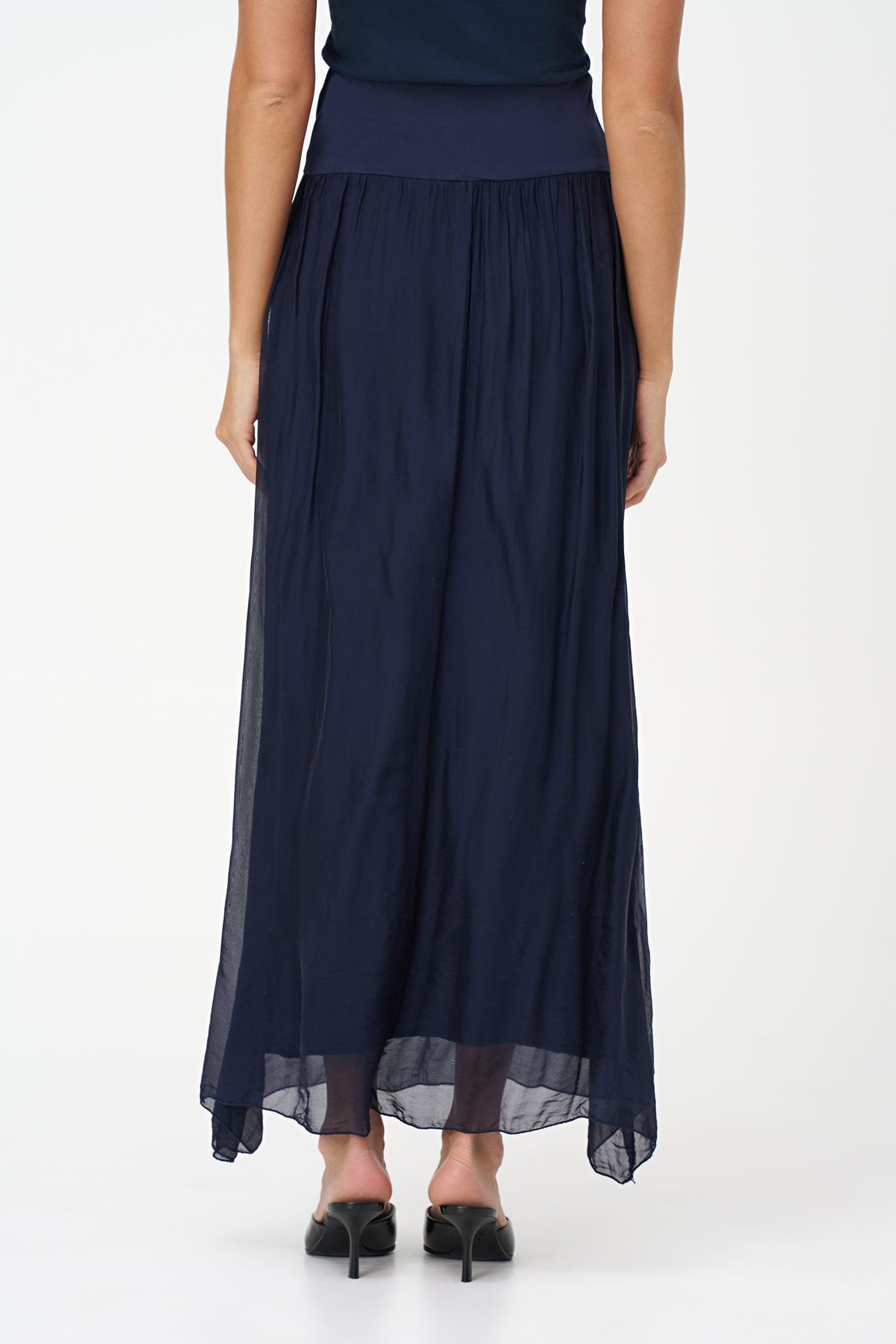 Blue flowy maxi skirt in semi-sheer viscose-silk blend with wide smocked waistband, perfect for summer occasions and beach getaways.