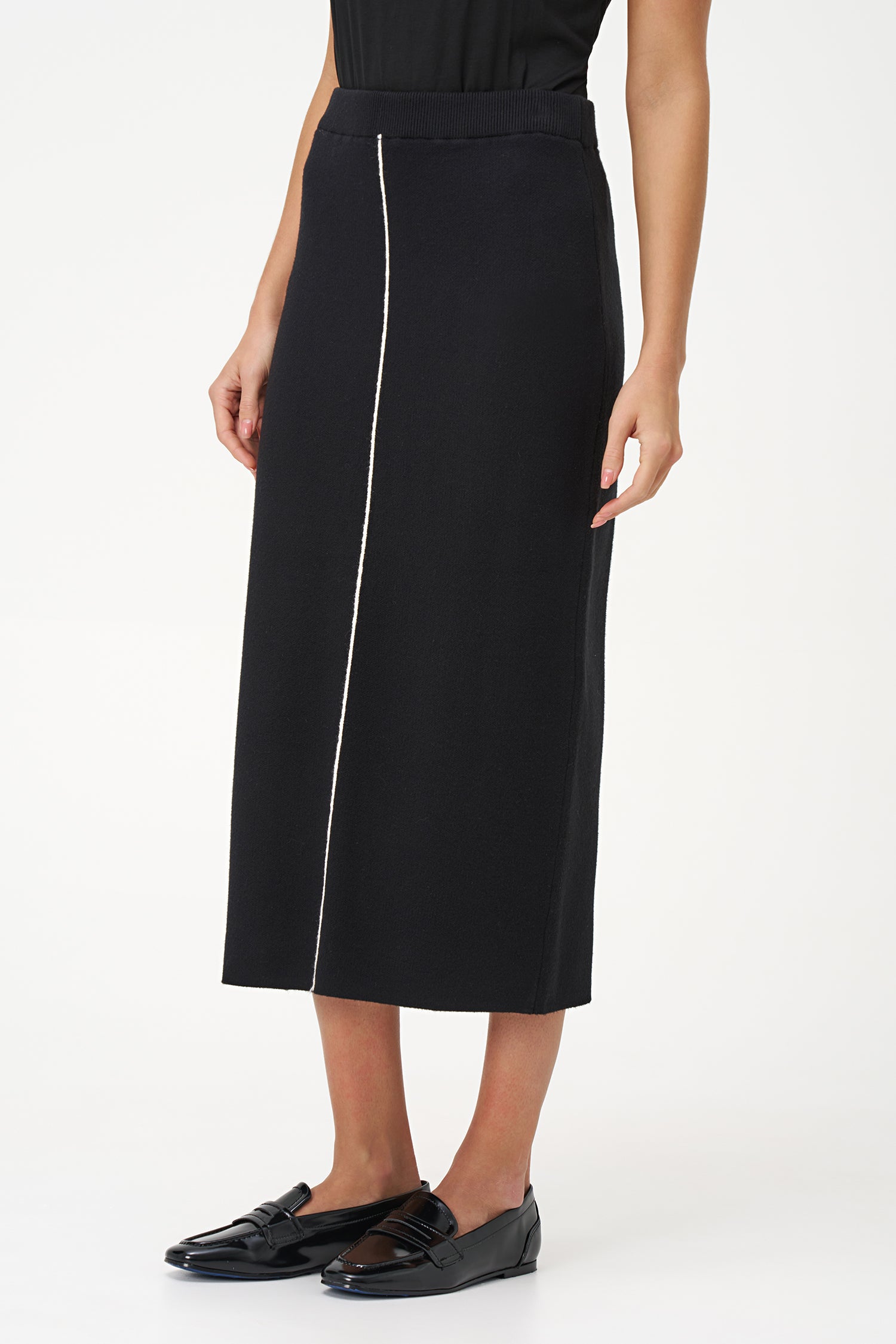 Black knit pencil skirt with front contrast seam detail, crafted in soft stretch rayon blend for a sleek, modern silhouette.