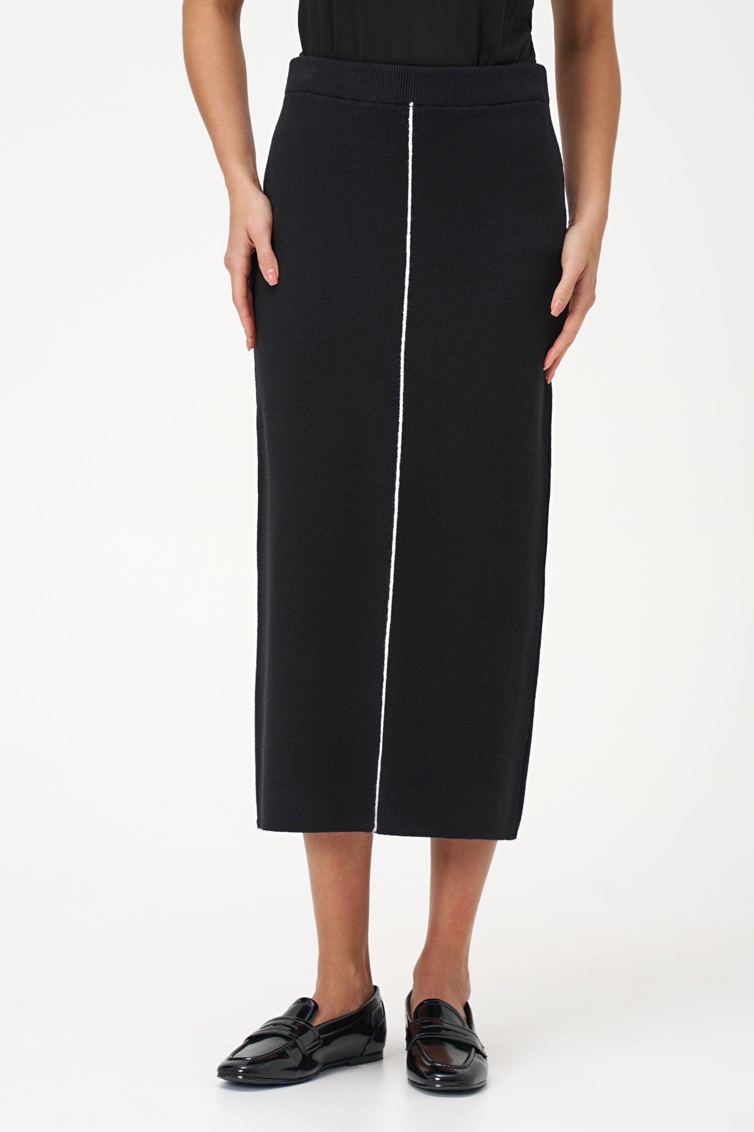Black knit pencil skirt with front contrast seam detail, crafted in soft stretch rayon blend for a sleek, modern silhouette.