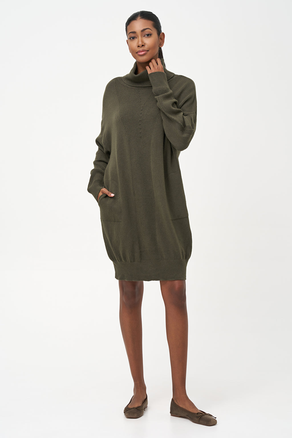 Green-colored knit turtleneck sweater dress with ribbed front panel and long sleeves for a cozy, elegant winter look.
