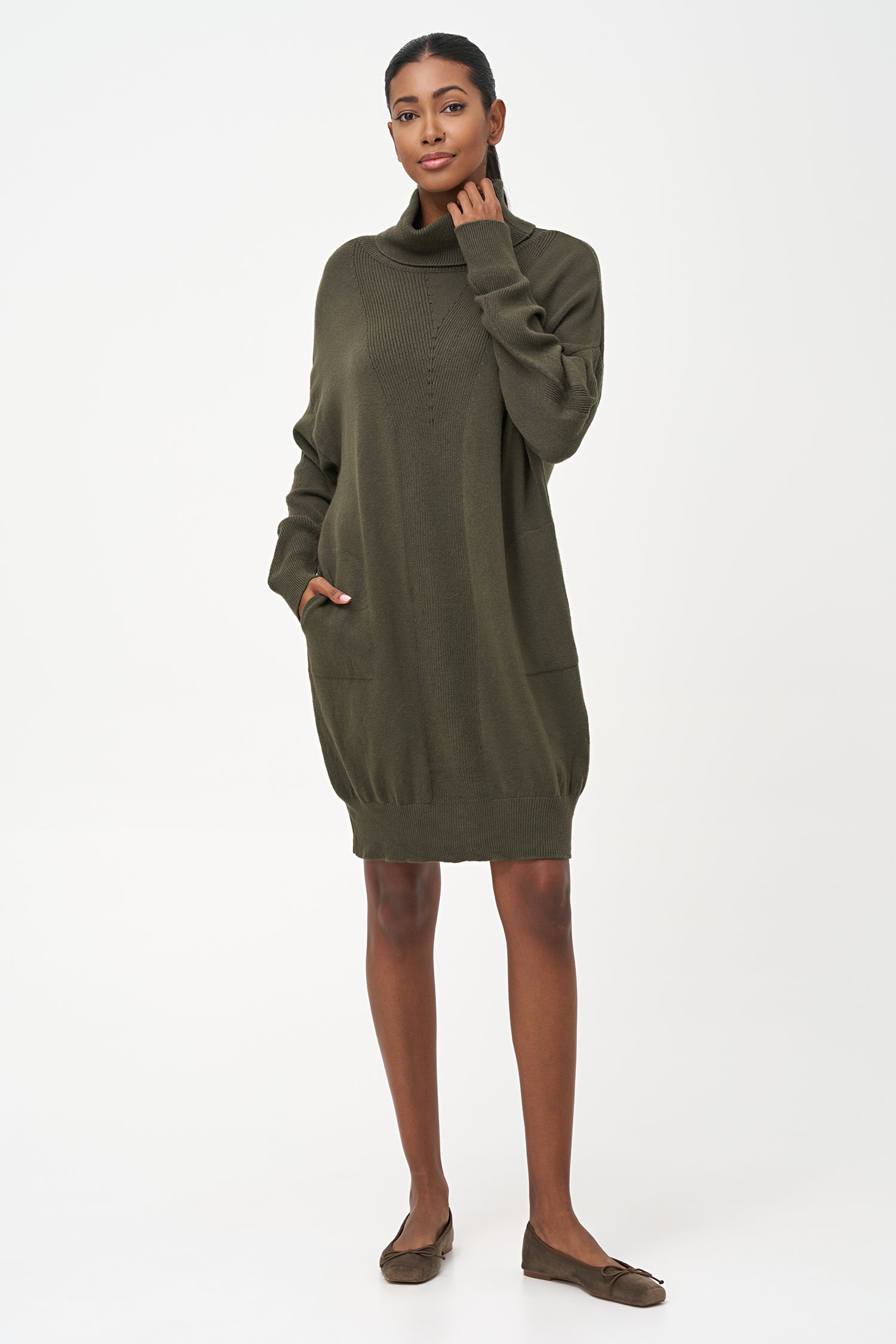 Green-colored knit turtleneck sweater dress with ribbed front panel and long sleeves for a cozy, elegant winter look.