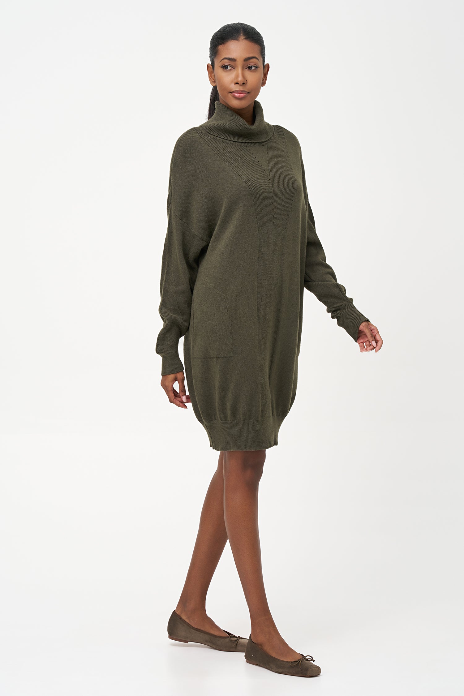 Green-colored knit turtleneck sweater dress with ribbed front panel and long sleeves for a cozy, elegant winter look.