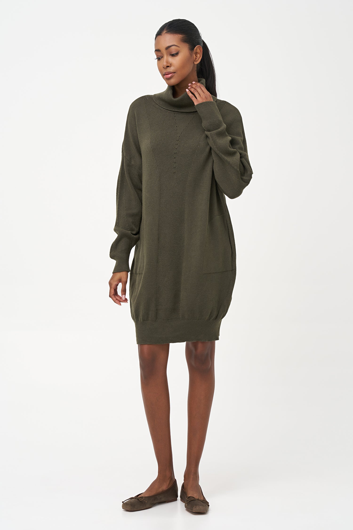 Green-colored knit turtleneck sweater dress with ribbed front panel and long sleeves for a cozy, elegant winter look.