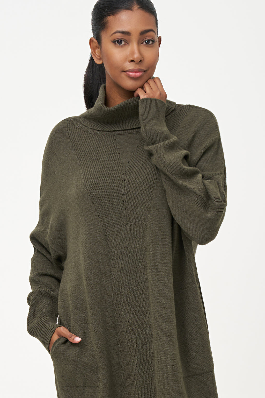 Green-colored knit turtleneck sweater dress with ribbed front panel and long sleeves for a cozy, elegant winter look.