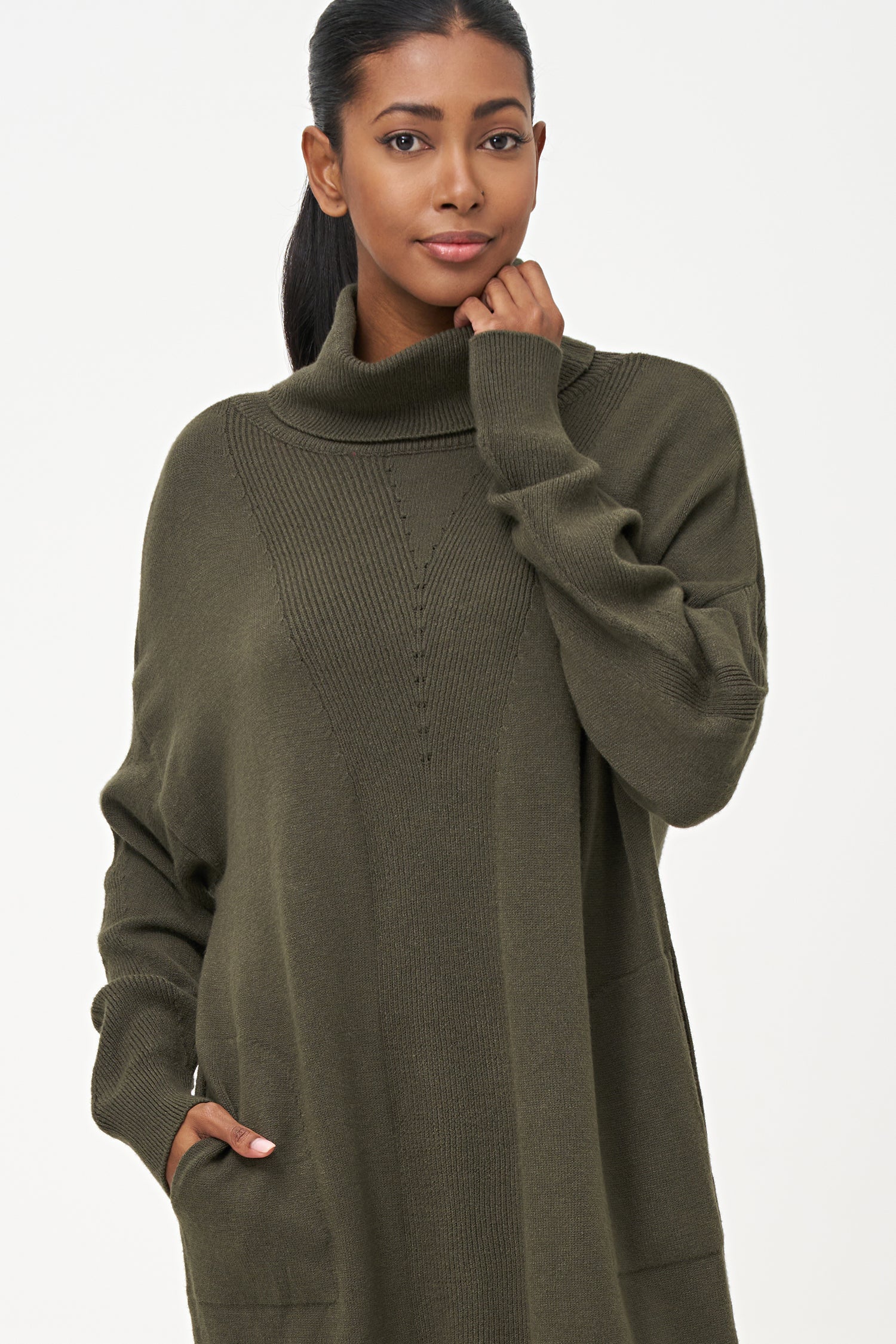 Green-colored knit turtleneck sweater dress with ribbed front panel and long sleeves for a cozy, elegant winter look.