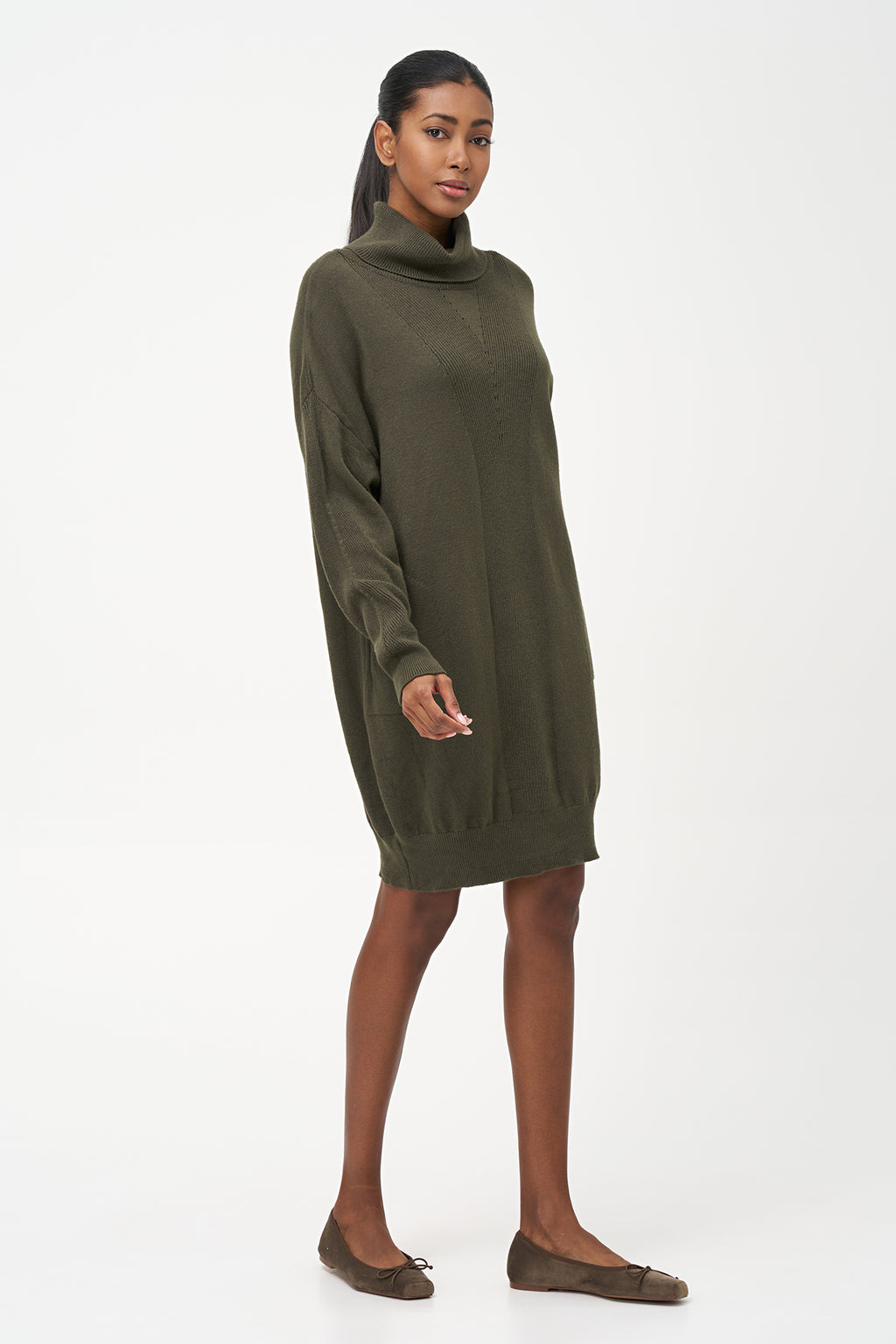 Green-colored knit turtleneck sweater dress with ribbed front panel and long sleeves for a cozy, elegant winter look.