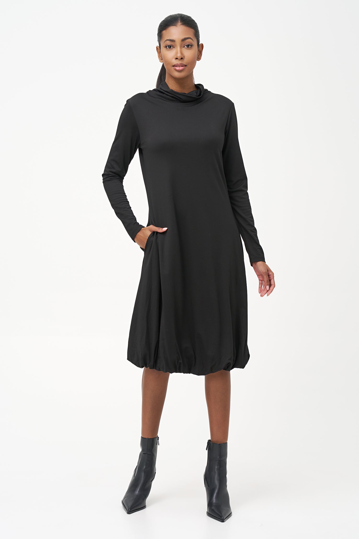 Long sleeve black dress with a soft turtleneck and relaxed A-line silhouette, crafted in stretchy ribbed knit fabric.