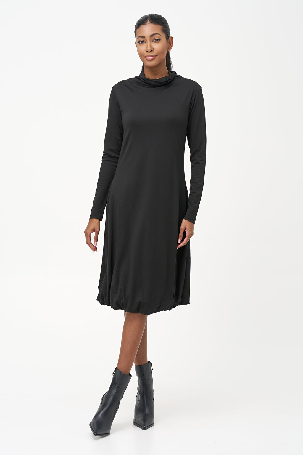 Long sleeve black dress with a soft turtleneck and relaxed A-line silhouette, crafted in stretchy ribbed knit fabric.