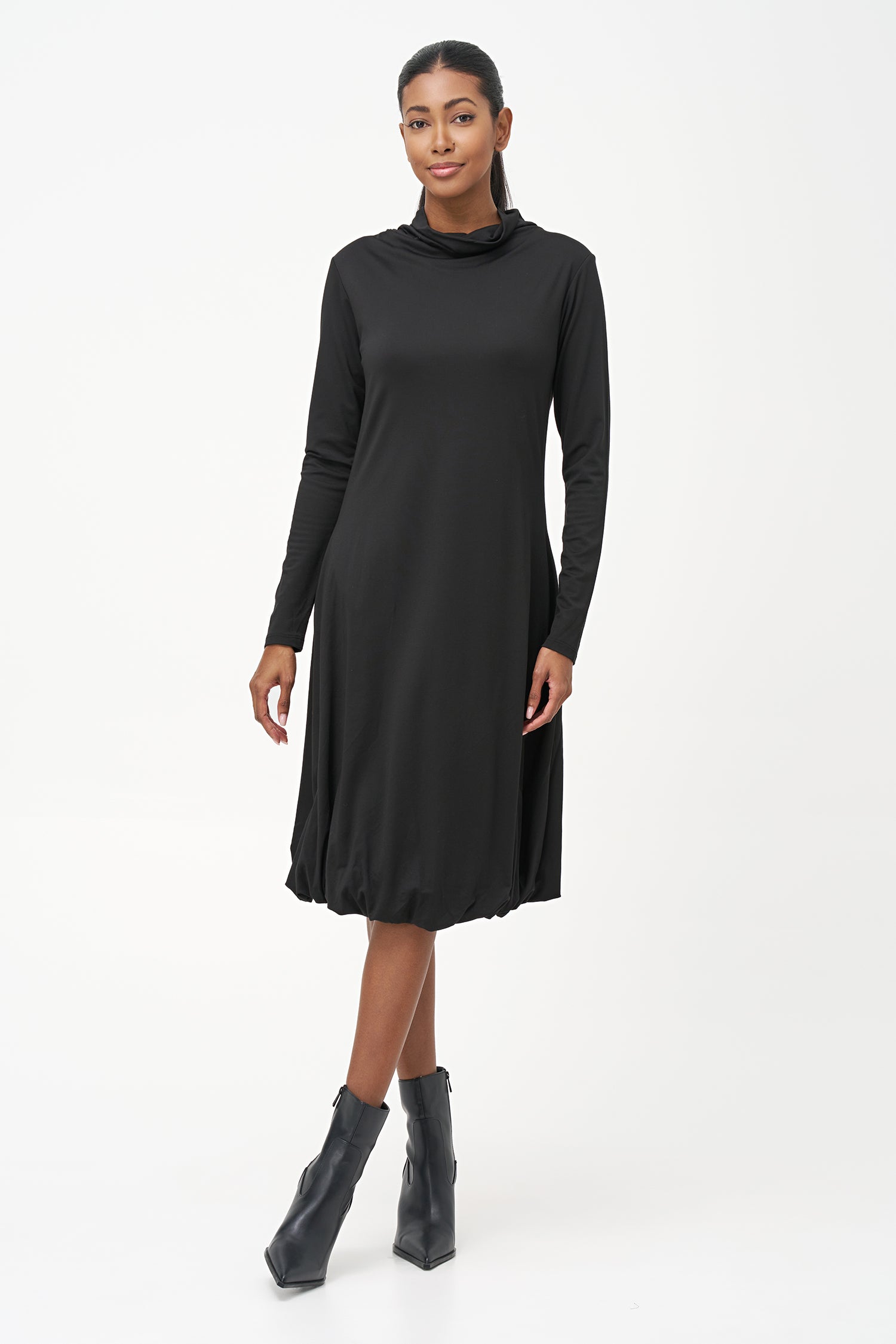 Long sleeve black dress with a soft turtleneck and relaxed A-line silhouette, crafted in stretchy ribbed knit fabric.